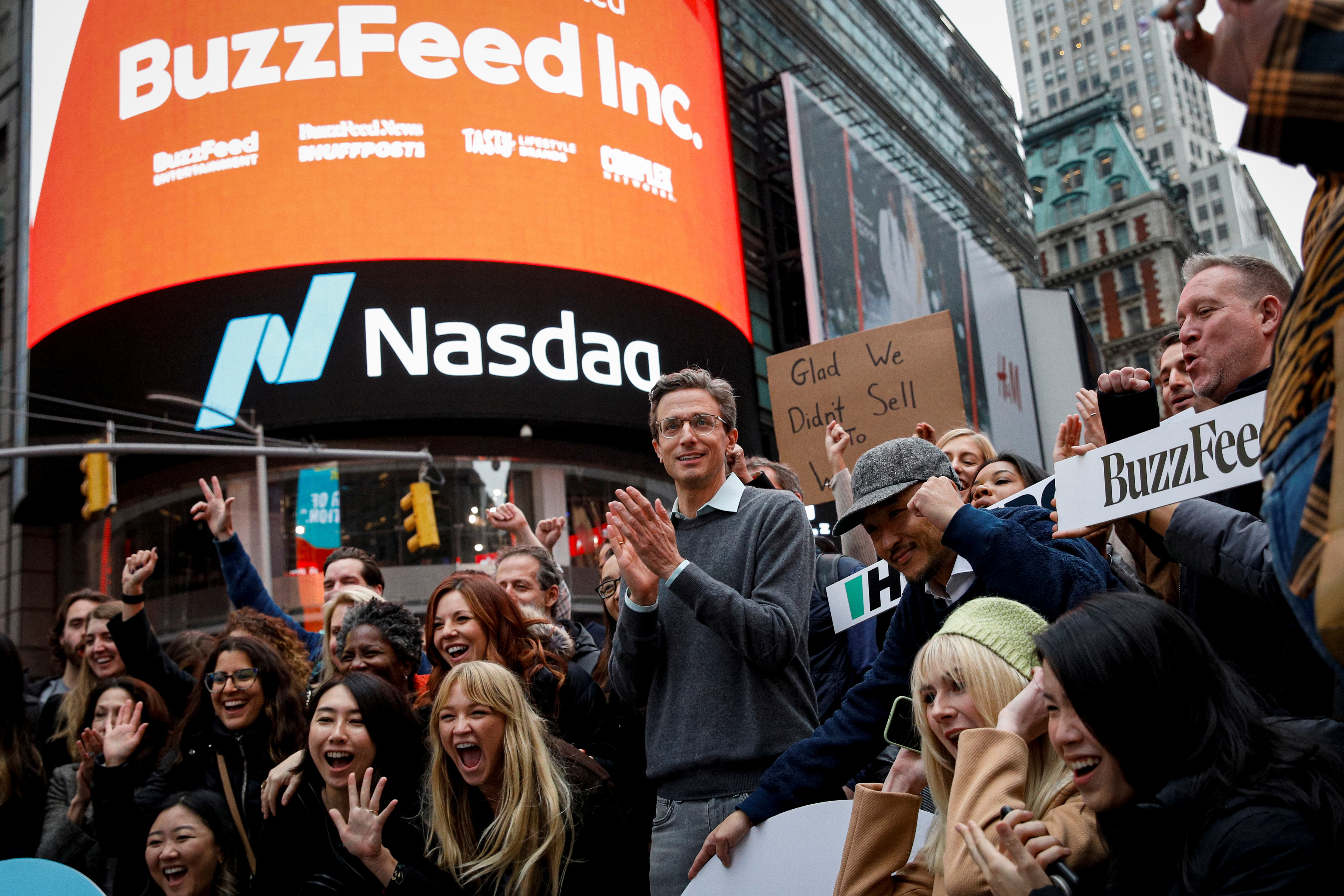 Jonah Peretti, founder and CEO of BuzzFeed, poses with employees to celebrate the company's debut outside the Nasdaq Market in Times Square in New York City, U.S., December 6, 2021.