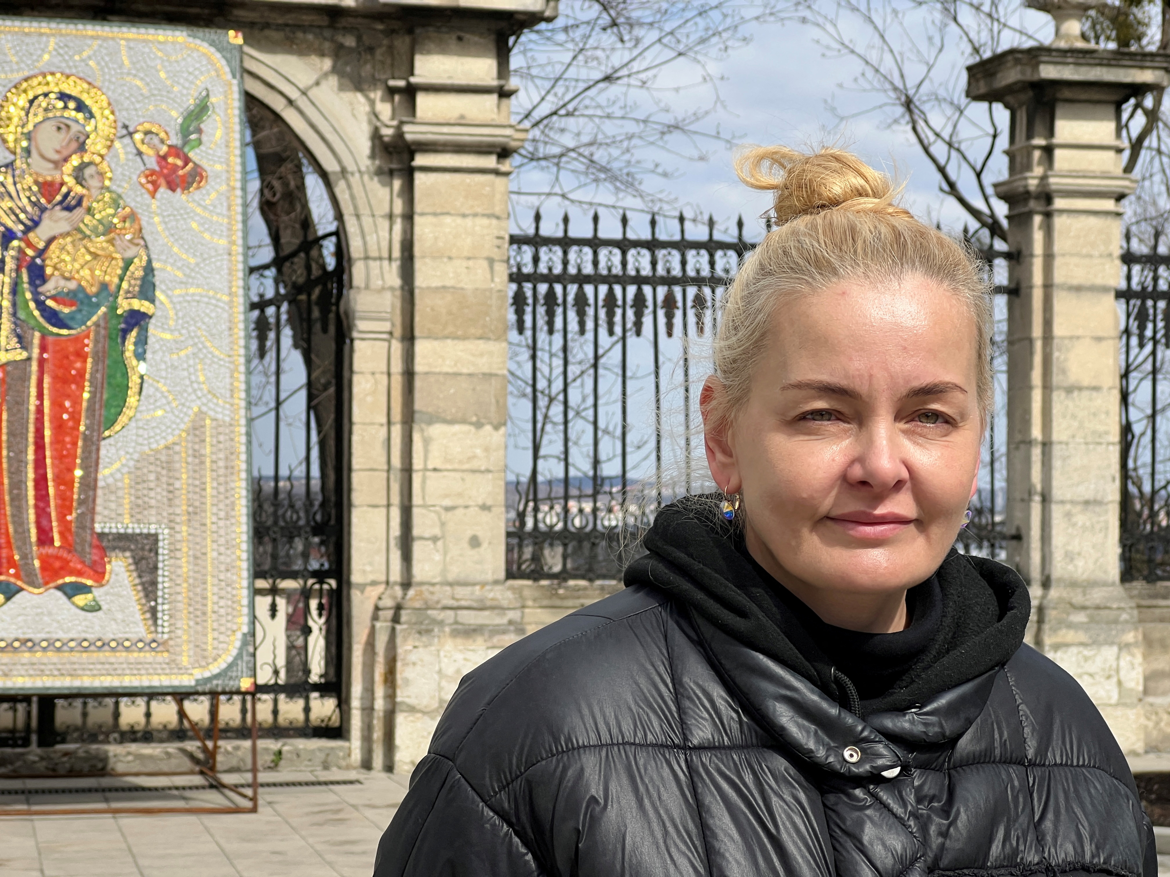Ukrainian Luidmyla Nazarova waits for humanitarian aid to depart St. George's Cathedral, in Lviv