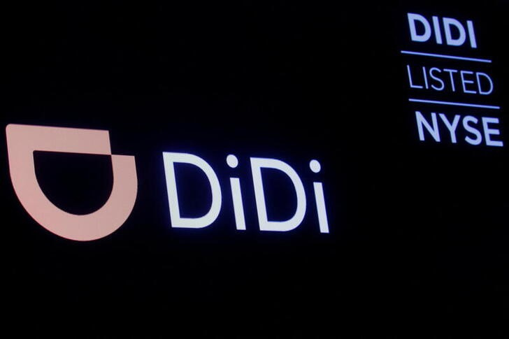 A screen displays trading information for ride-hailing giant Didi Global on the floor of the NYSE in New York