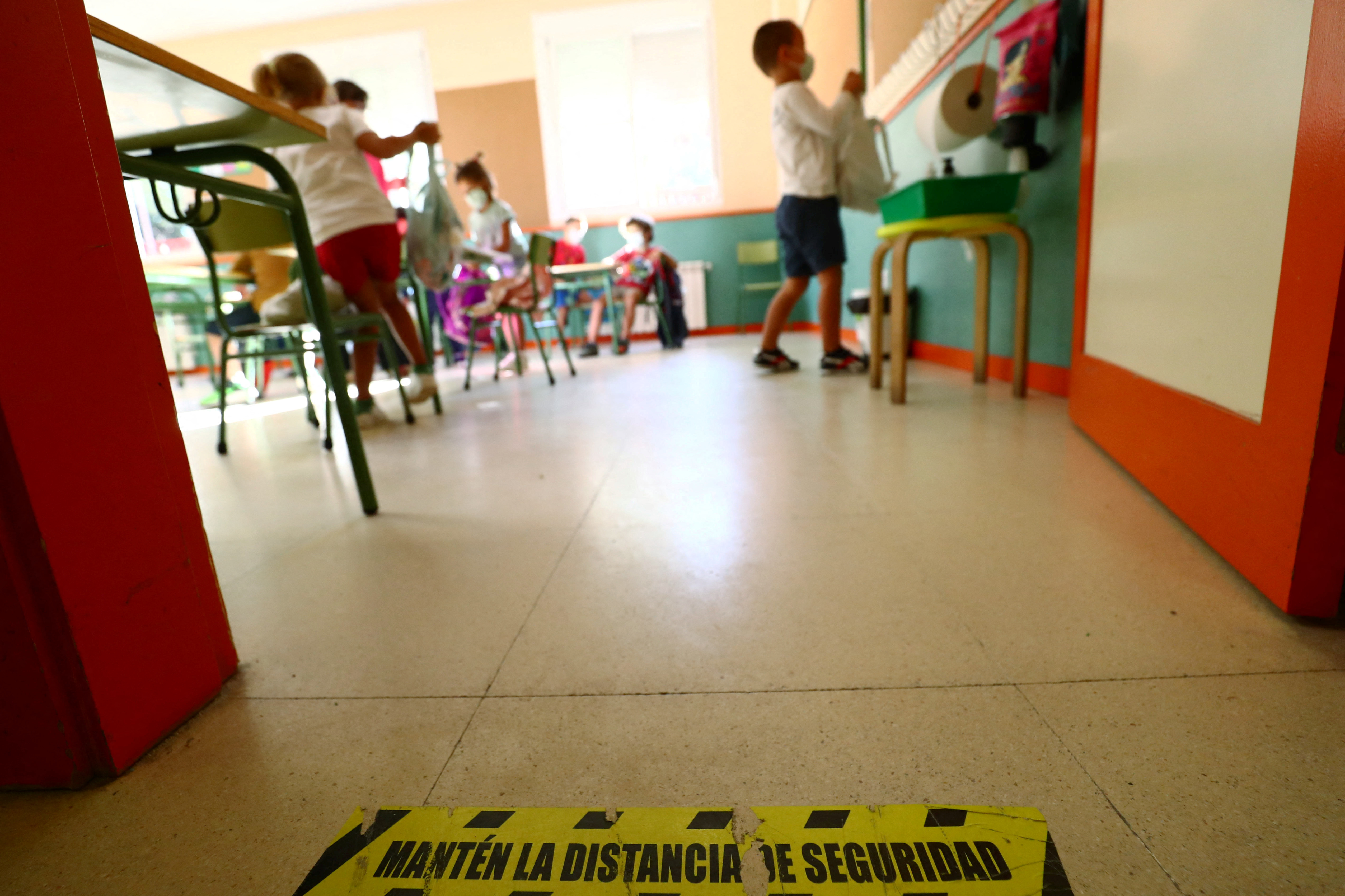 A social distancing mark is seen on the floor as pupils arrive on the first day of school amid the coronavirus disease (COVID-19) outbreak in Madrid