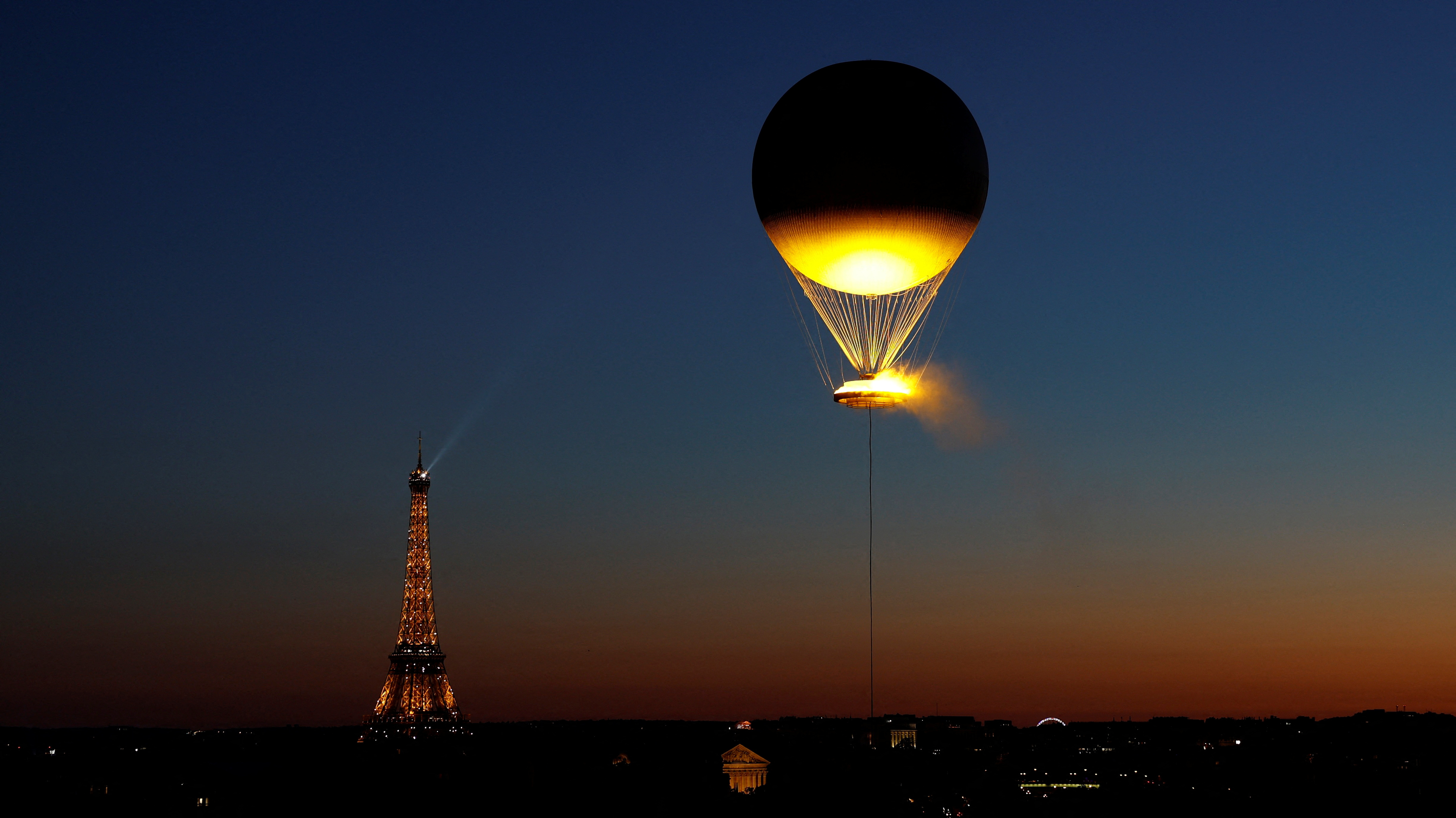 In pictures: Olympic cauldron dazzles above Paris each night - August 5 ...