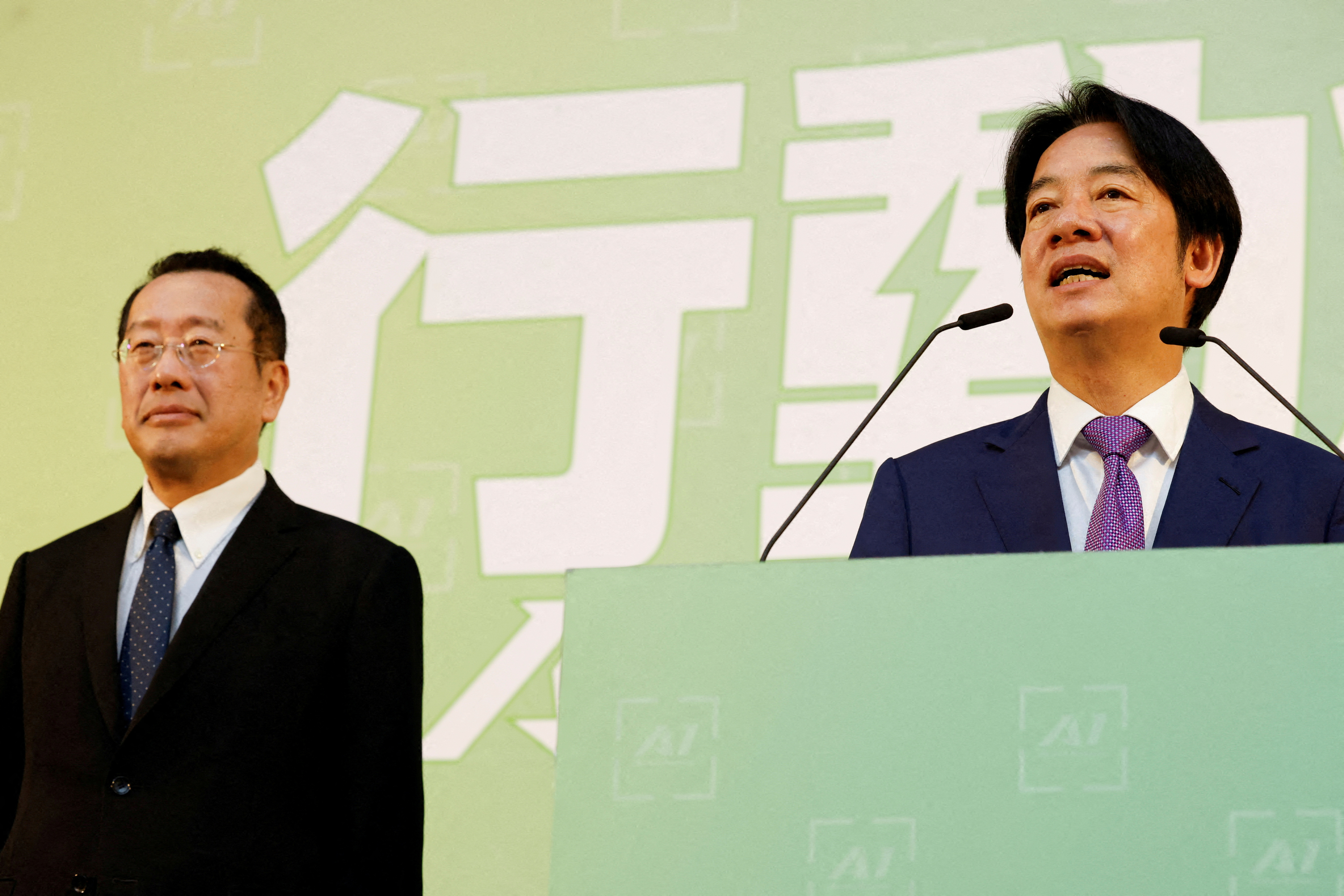 Taiwan President-elect Lai Ching-te speaks as incoming Defence Minister Wellington Koo stands next to him during a press conference, in Taipei