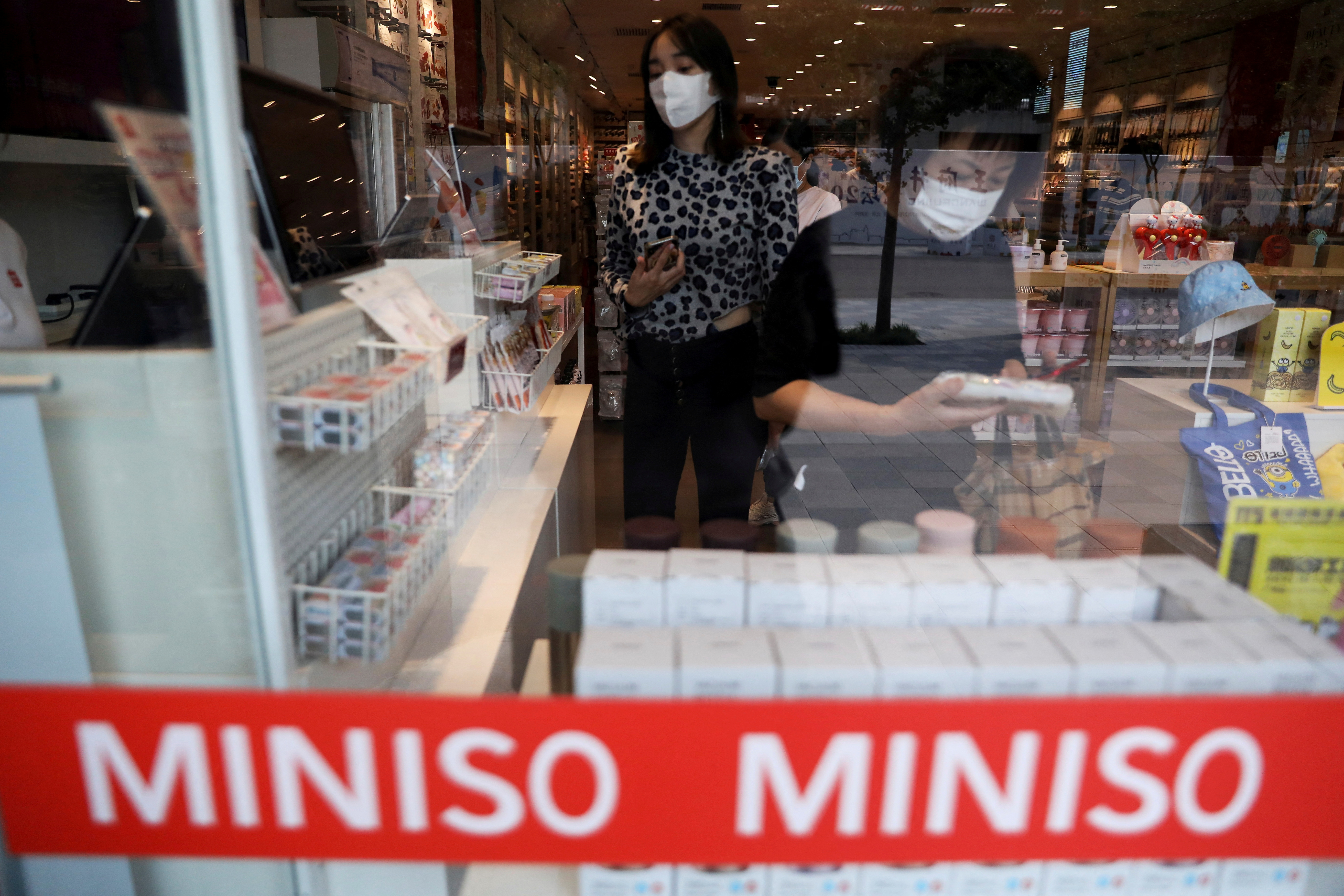Customers shop at a store of Chinese retailer MINISO Group in Beijing