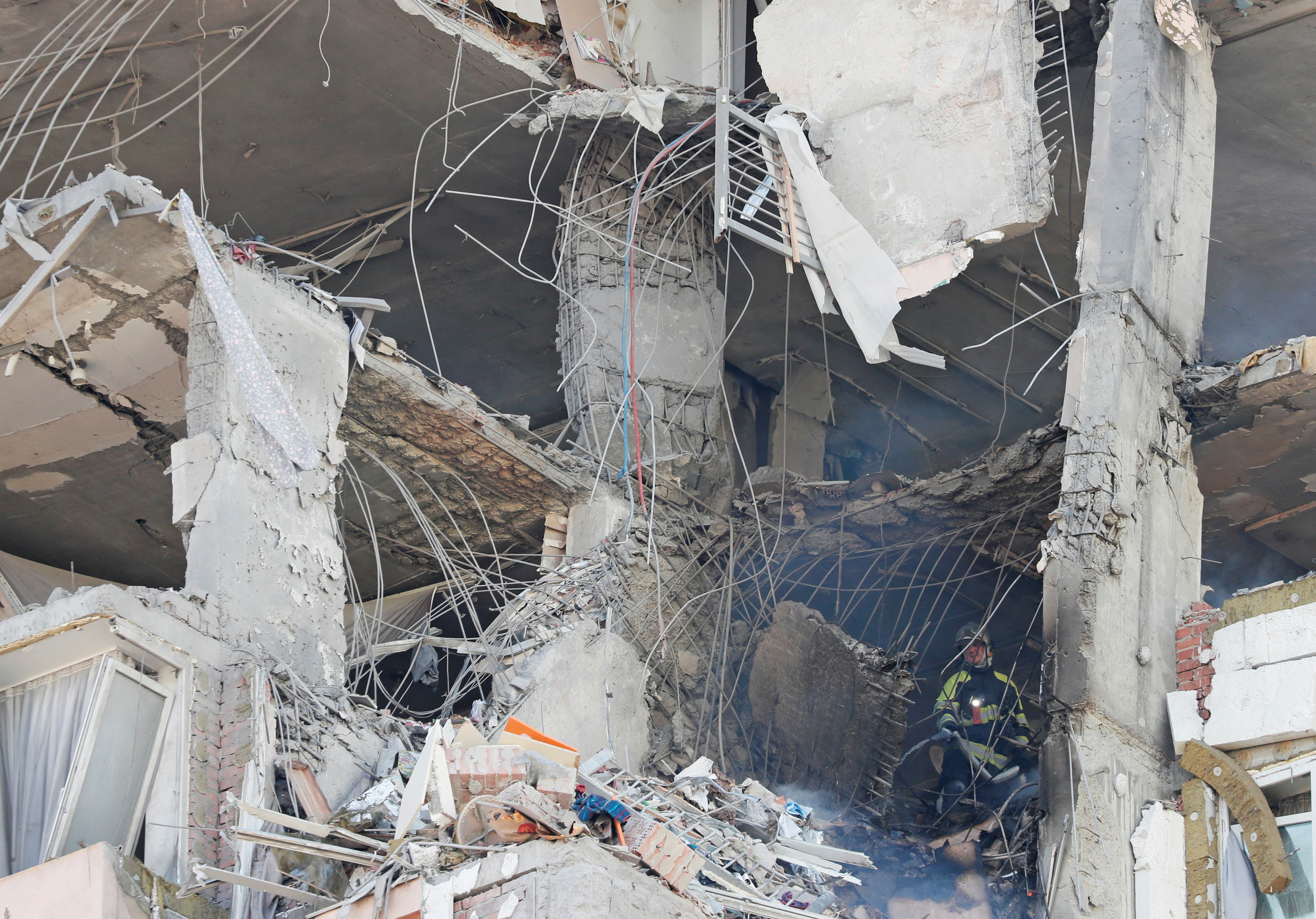 A firefighter works inside an apartment building damaged by recent shelling in Kyiv, Ukraine February 26, 2022. REUTERS/Gleb Garanich