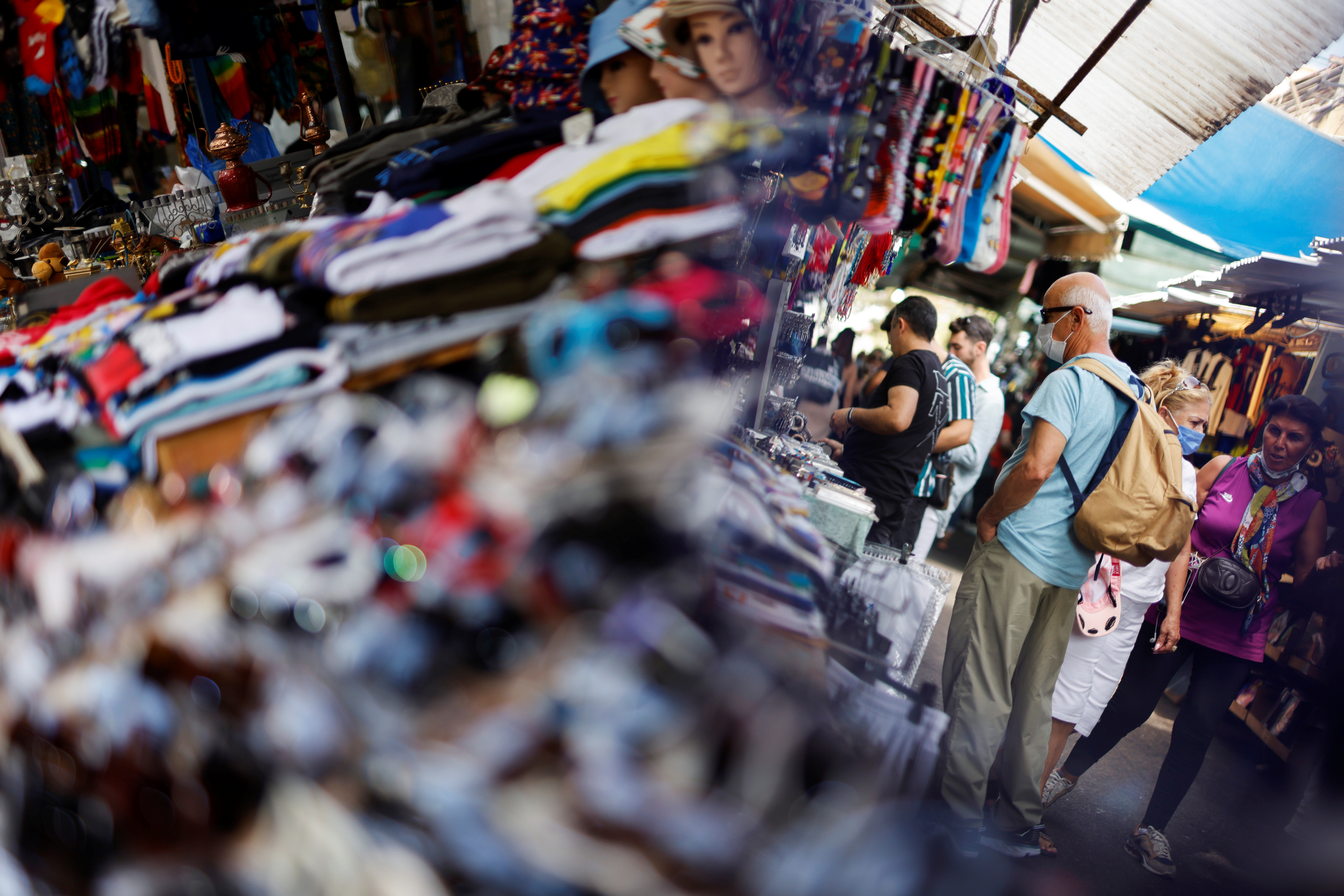 Shoppers explore the Carmel Market as coronavirus disease (COVID-19) restrictions ease in Tel Aviv