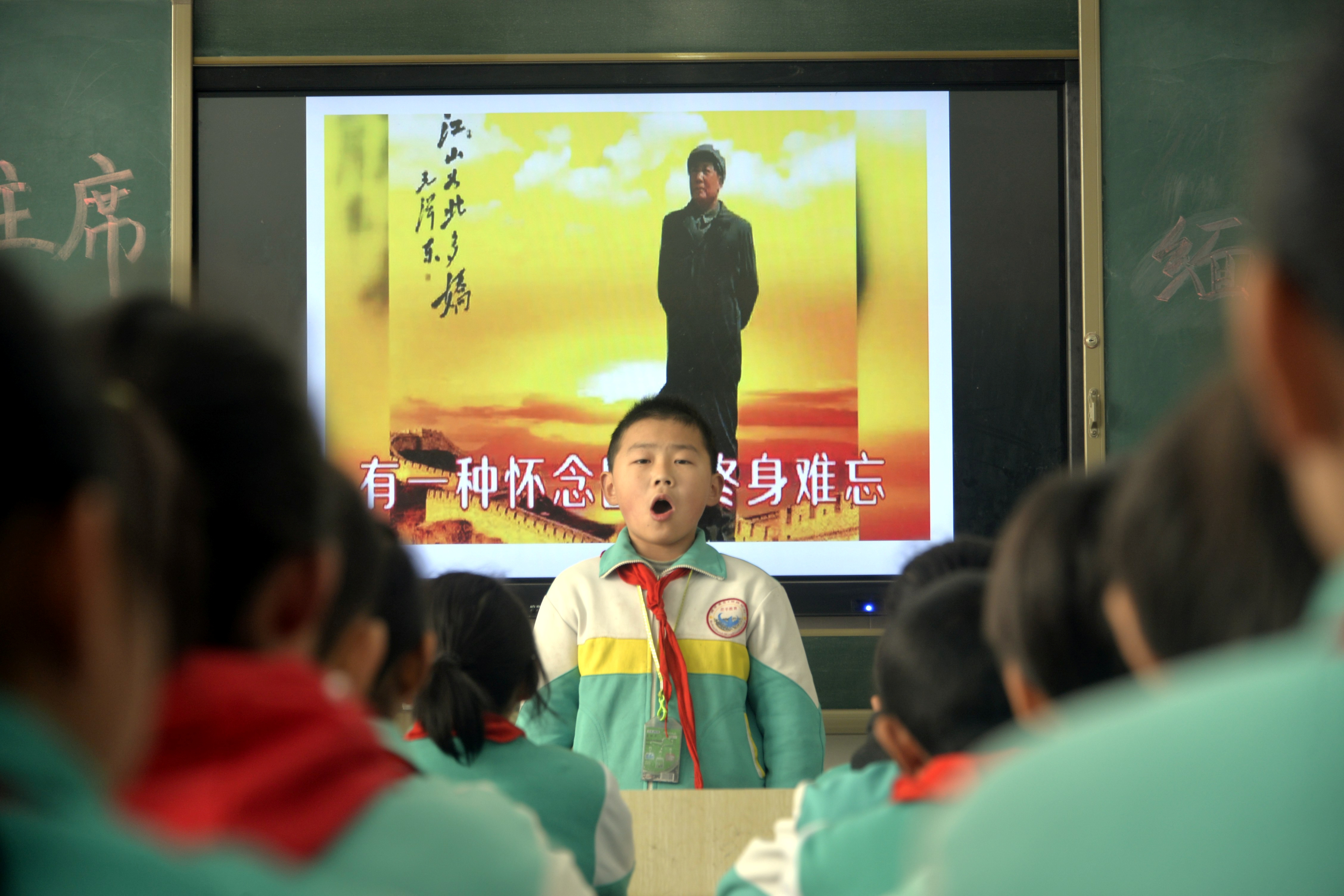 Students recite a poem by China's late Chairman Mao Zedong on the 125th anniversary of Mao's birthday, at a primary school in Liaocheng