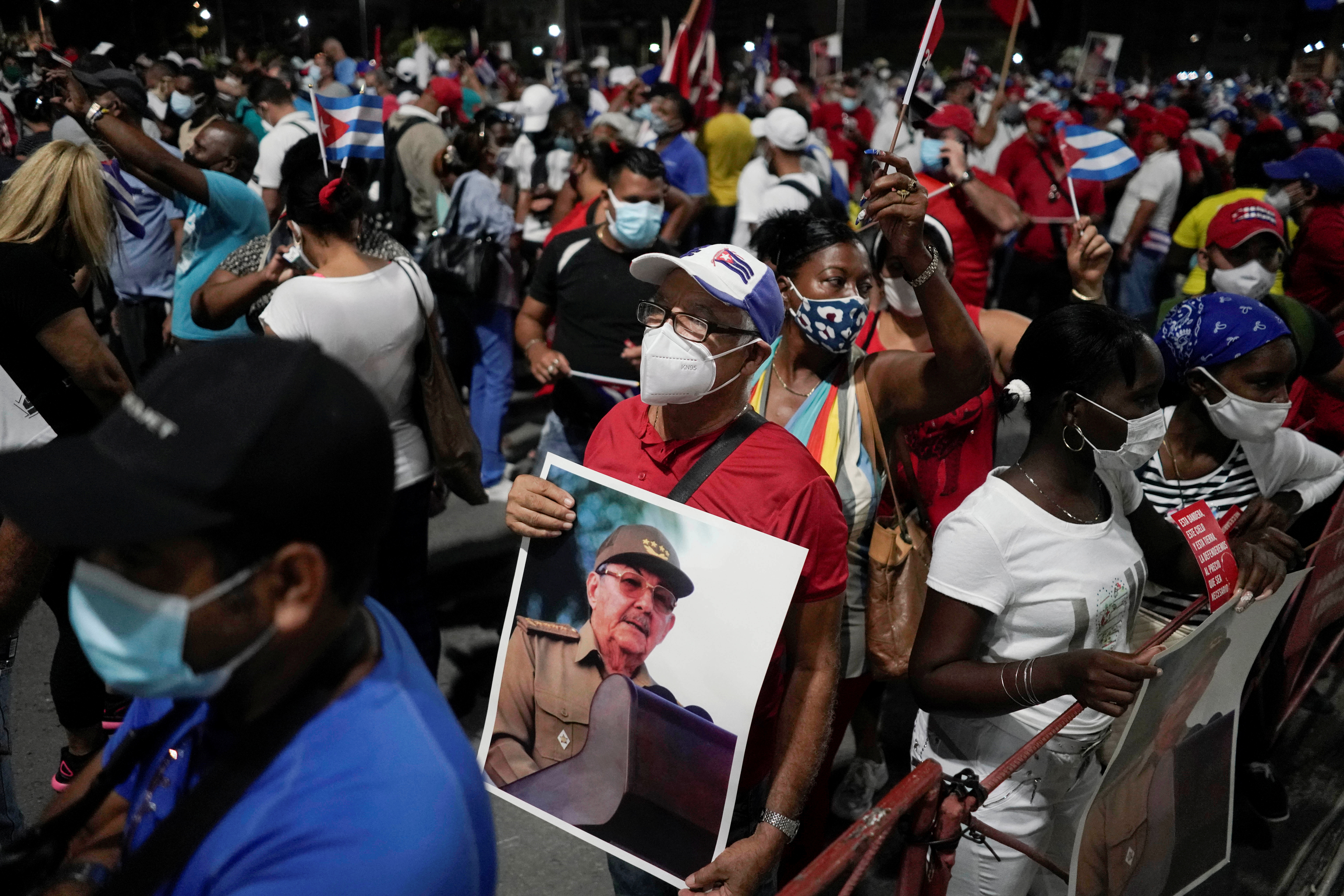 A man holds an image of Raul Castro durig a rally in Havana