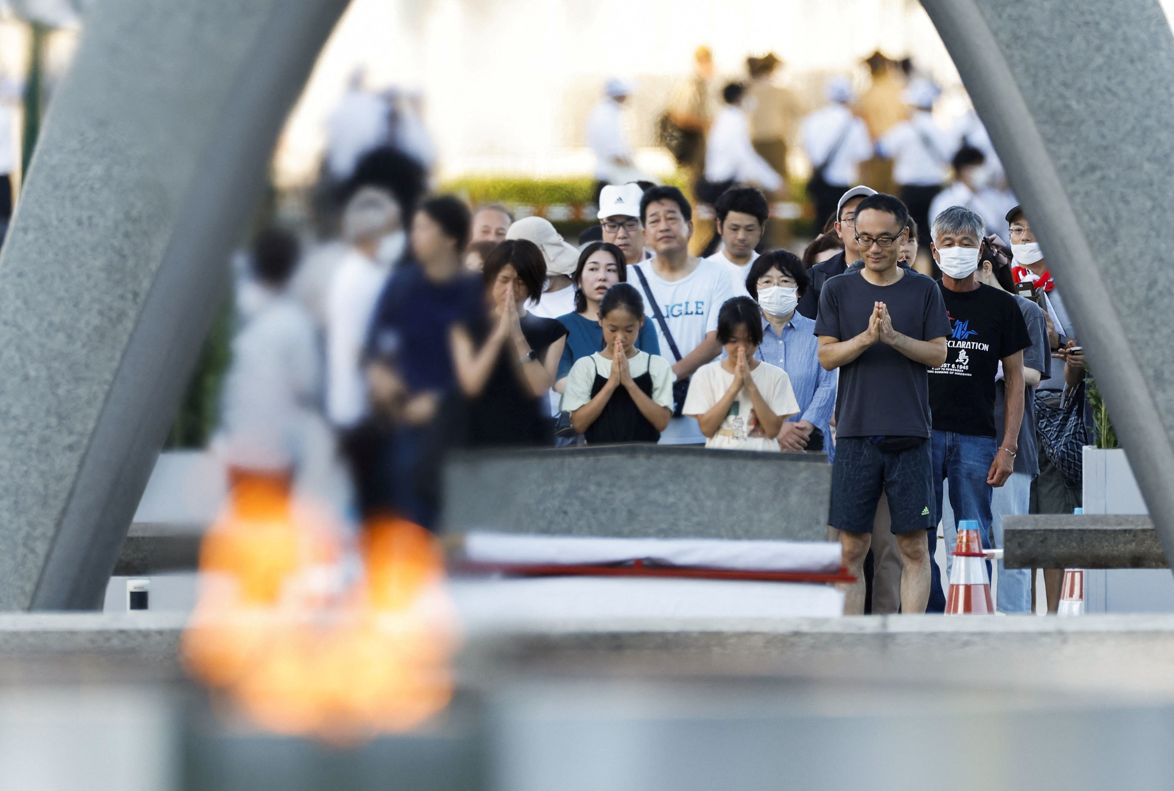 People pray in front of the cenotaph for the victims of the 1945 atomic bombing, on the anniversary of the world's first atomic bombing, at Peace Memorial Park in Hiroshima