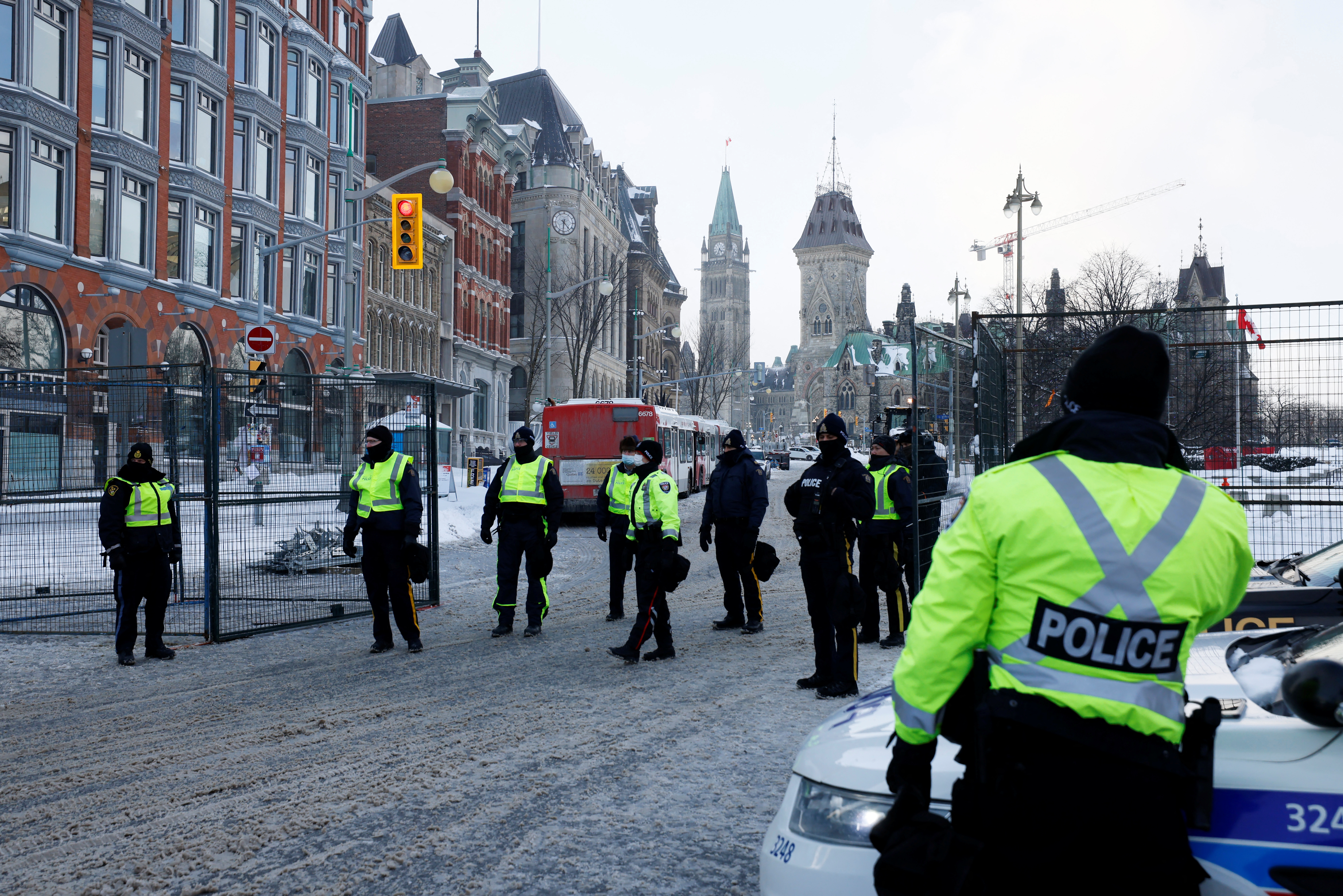 Canadian police officers stand guard as they work to restore normality to the capital while trucks and demonstrators continue to occupy the downtown core for more than three weeks to protest against pandemic restrictions in Ottawa, Ontario, Canada, February 19, 2022.  REUTERS/Blair Gable