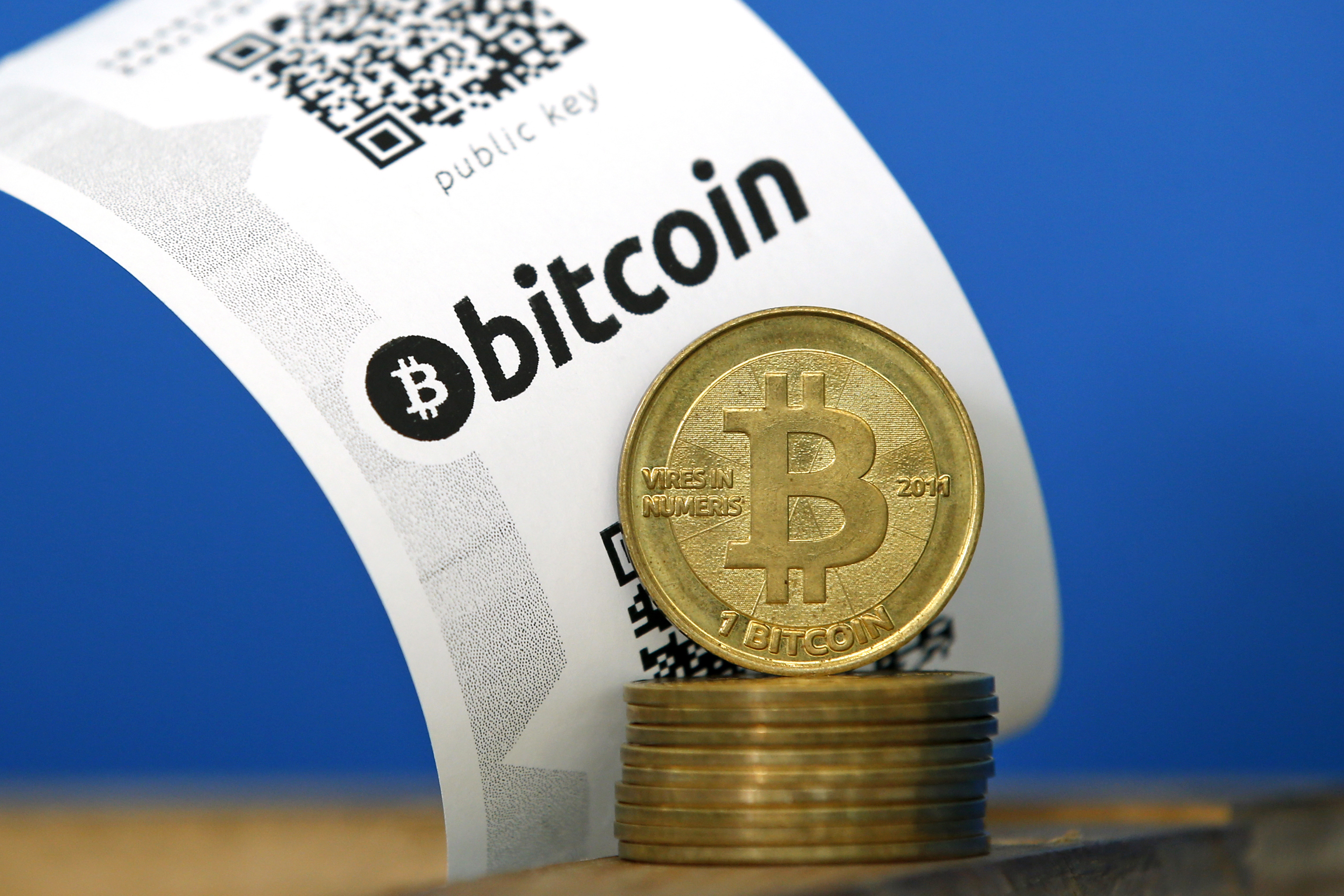 A bitcoin paper wallet with QR codes and coins are seen in an illustration picture taken at La Maison du Bitcoin in Paris July 11, 2014.