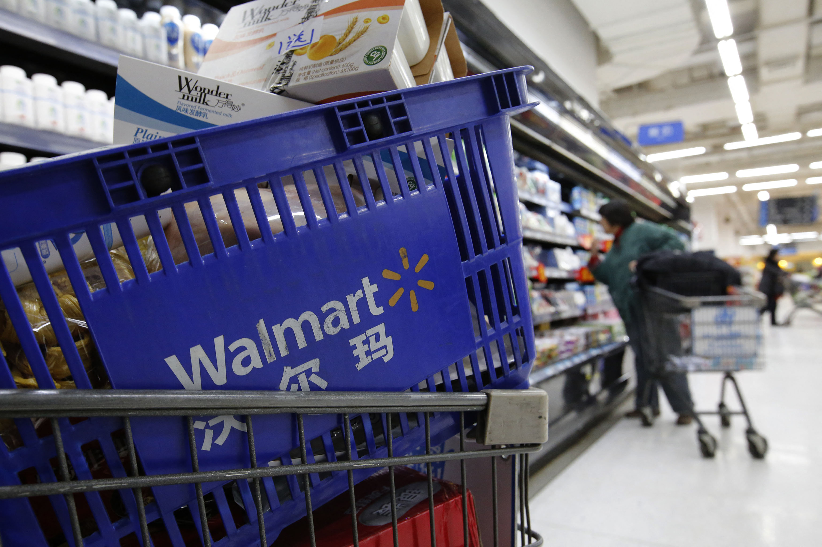 A shopping cart full of products is seen as a customer shops at a Wal-Mart store in Beijing