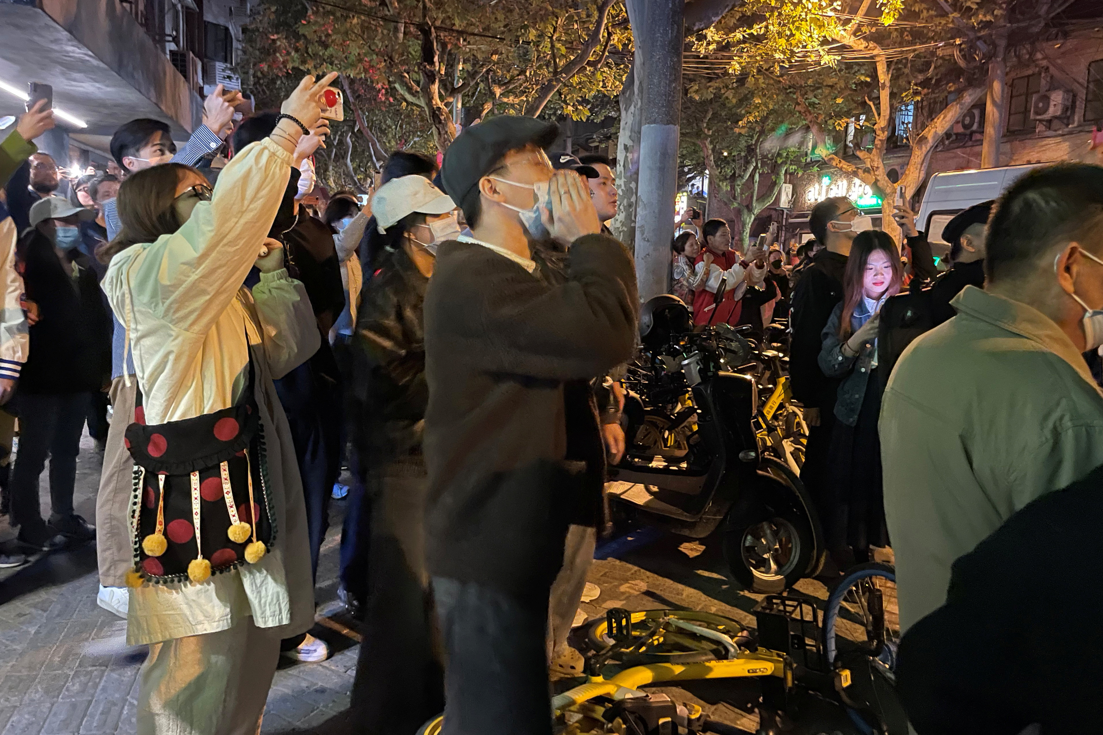 People hold their mobile phones in Shanghai