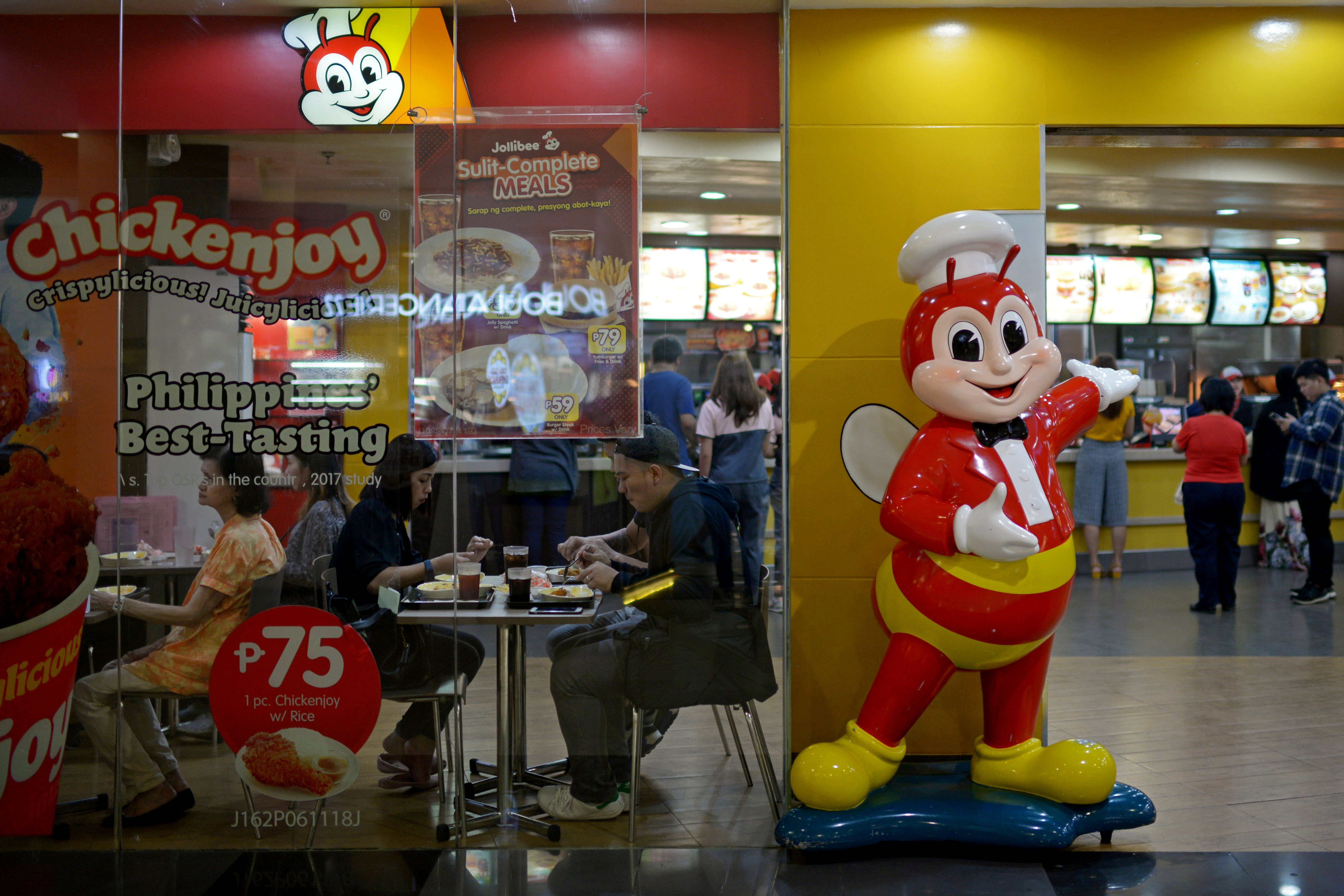 Customers dine in a branch of Jollibee in Manila
