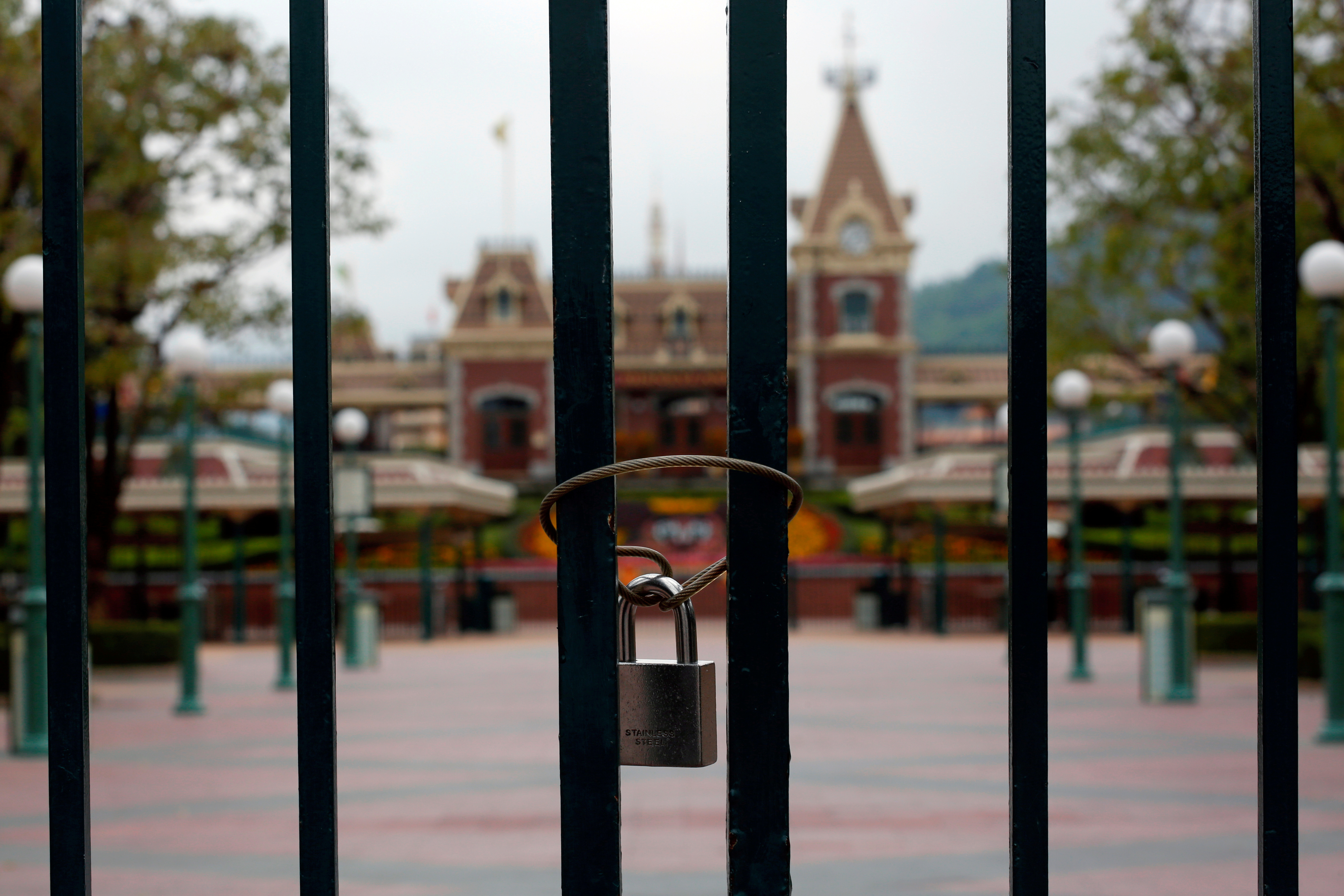 A locked gate is seen after the Hong Kong Disneyland theme park has been closed, following the coronavirus outbreak in Hong Kong, China January 26, 2020. REUTERS/Tyrone Siu/File Photo