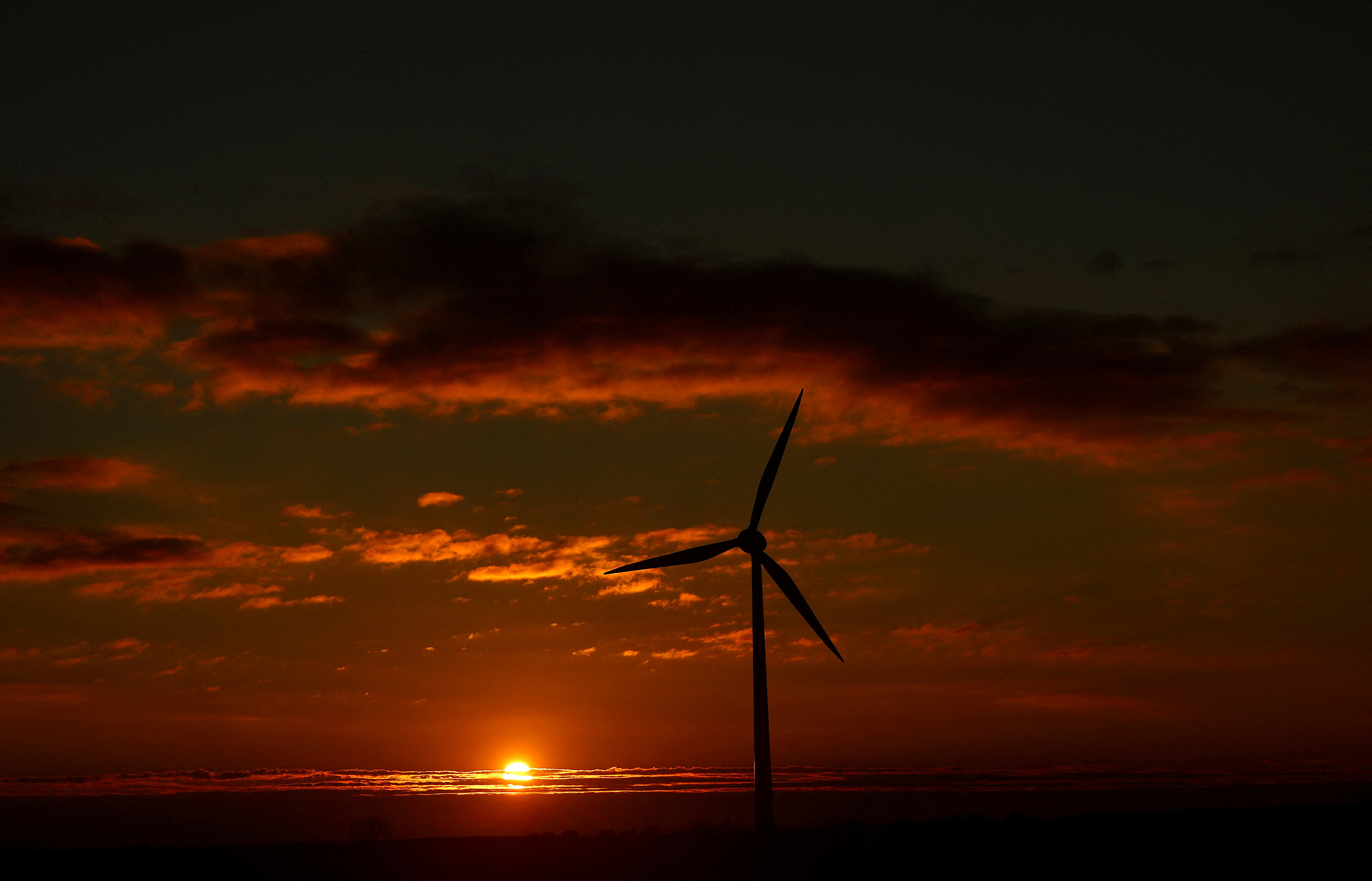 A wind turbine is seen during sunset near Weselitz