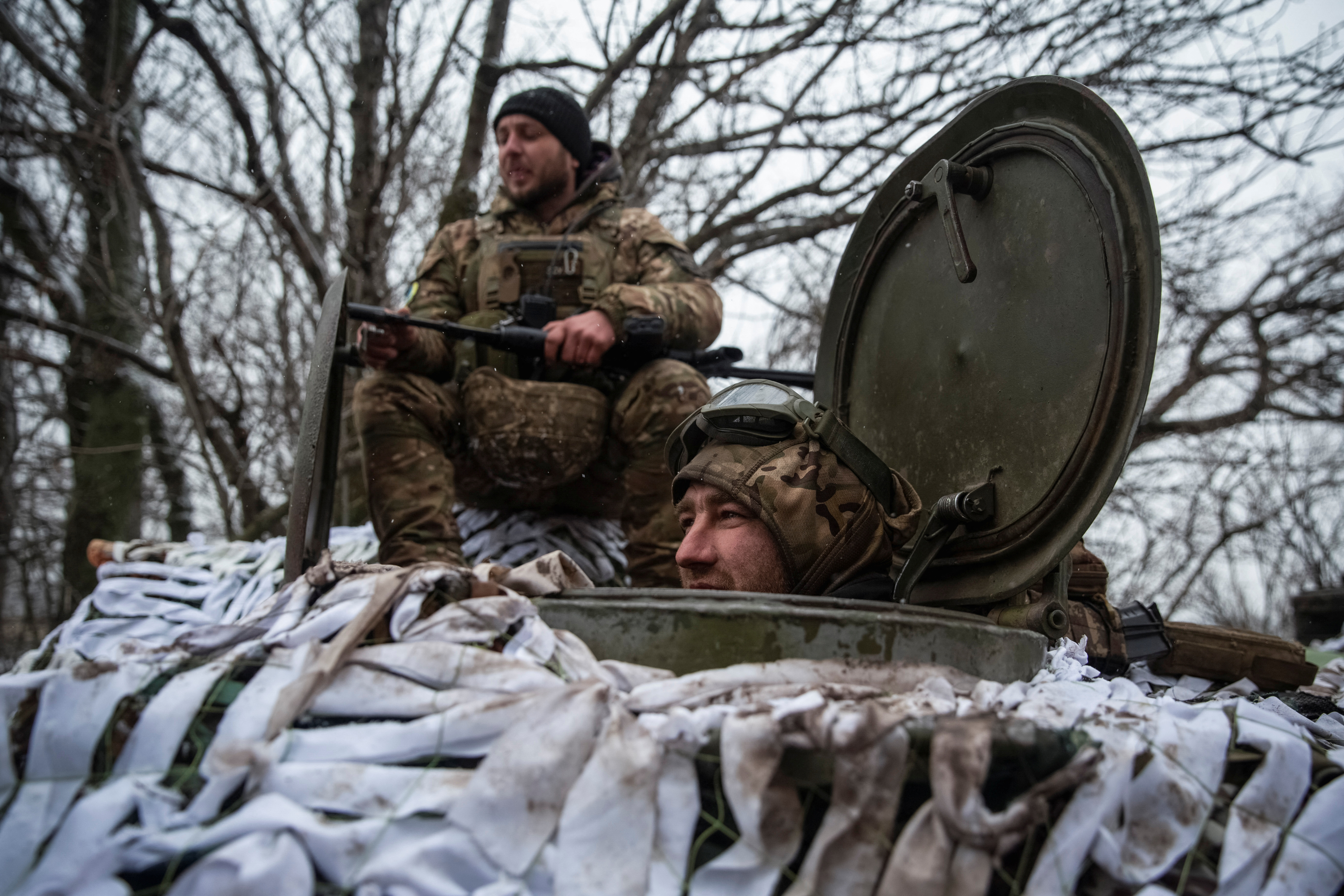 Ukrainian servicemen stand at their positions near a front line in Donetsk region