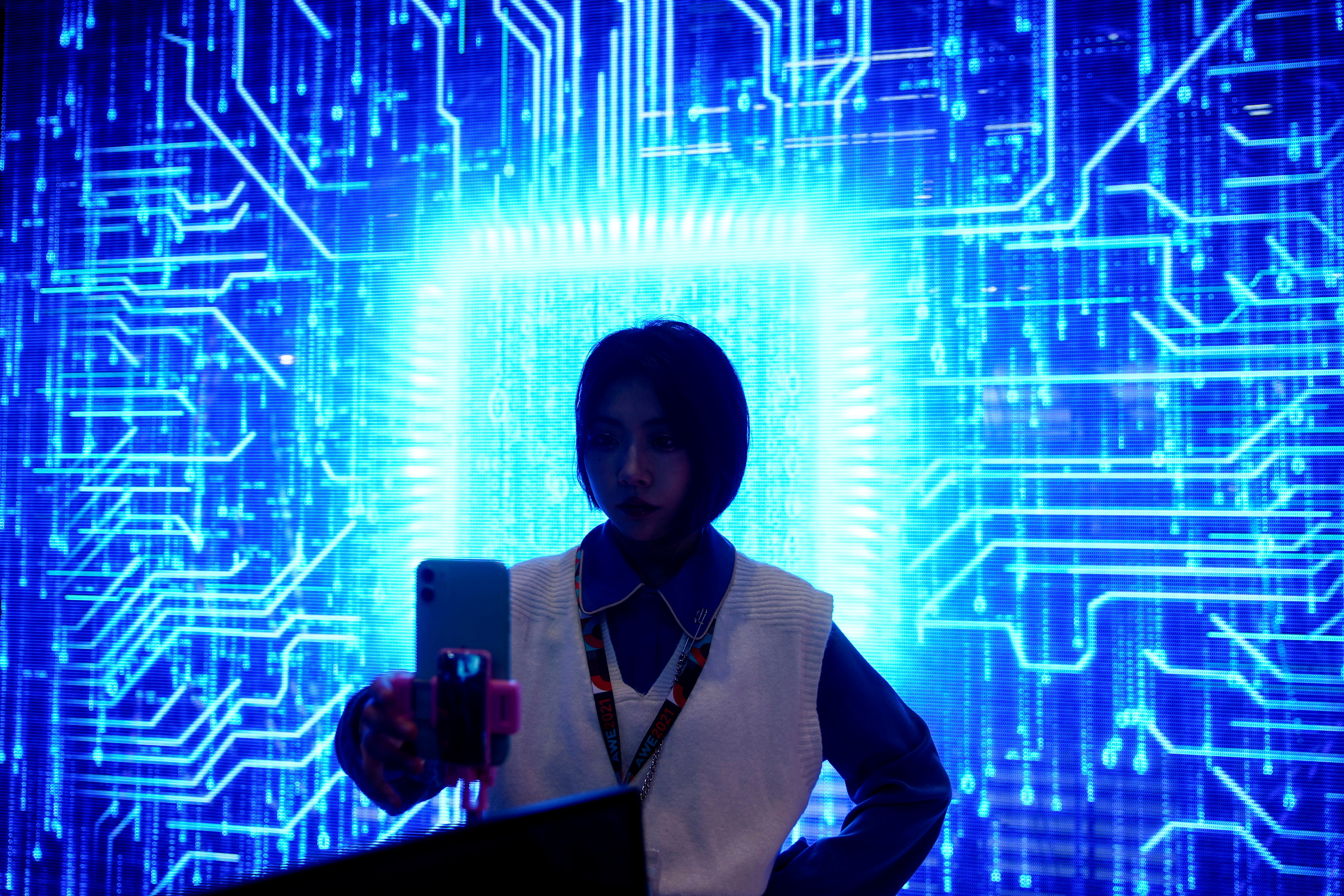 A woman visits a semiconductor device display at the Appliance and Electronics World Expo (AWE) in Shanghai, China March 23, 2021. REUTERS/Aly Song