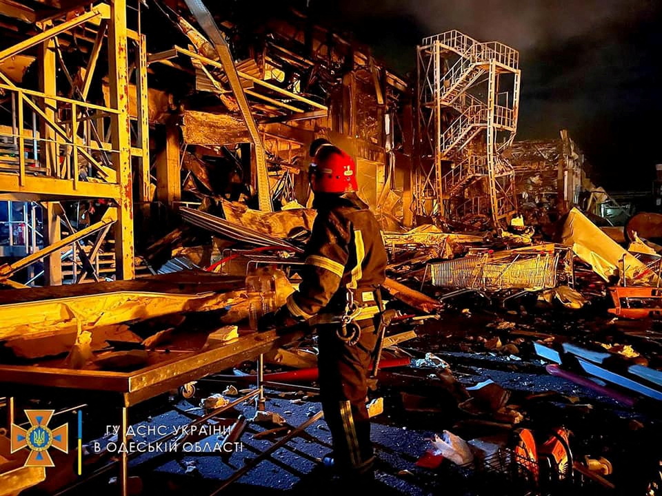 First responders work at the site of a missile strike, in Odesa