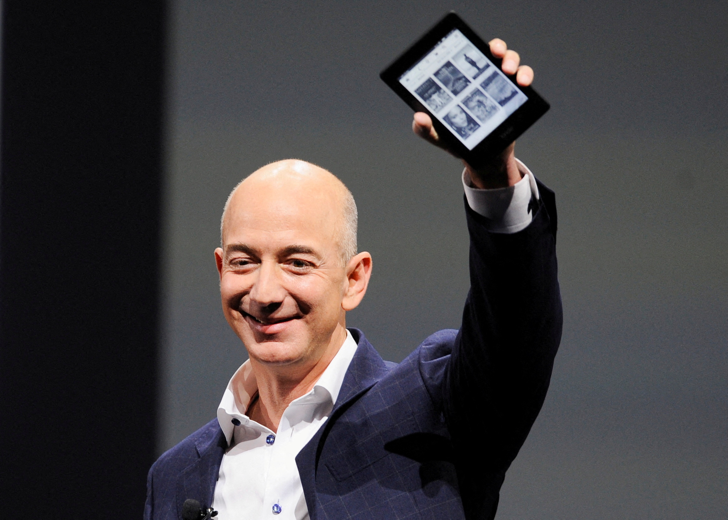 Amazon CEO Jeff Bezos holds up a Kindle Paperwhite during Amazon's Kindle Fire event in Santa Monica, California