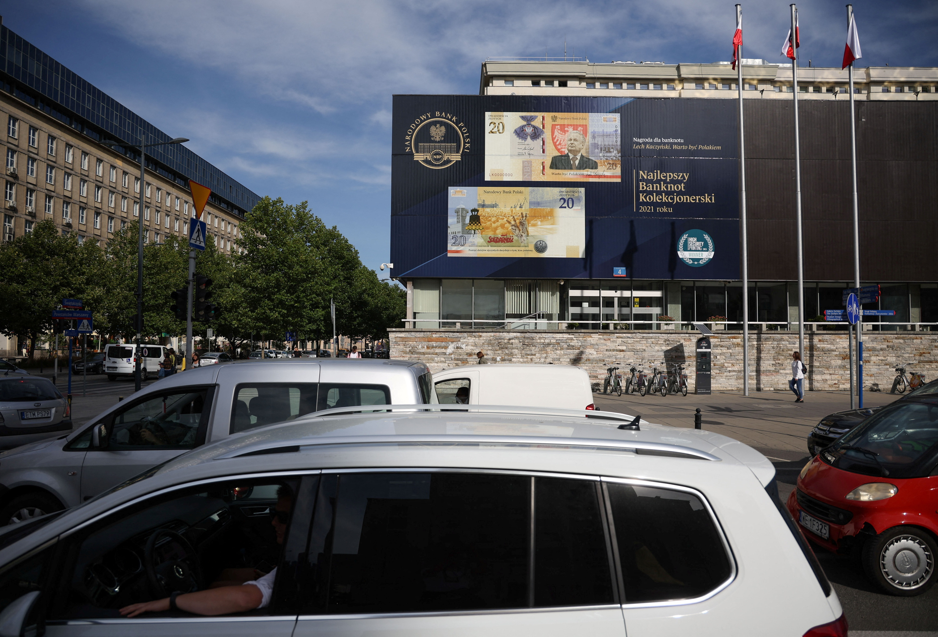 Cars pass in front of the Polish Central Bank (NBP) building in Warsaw