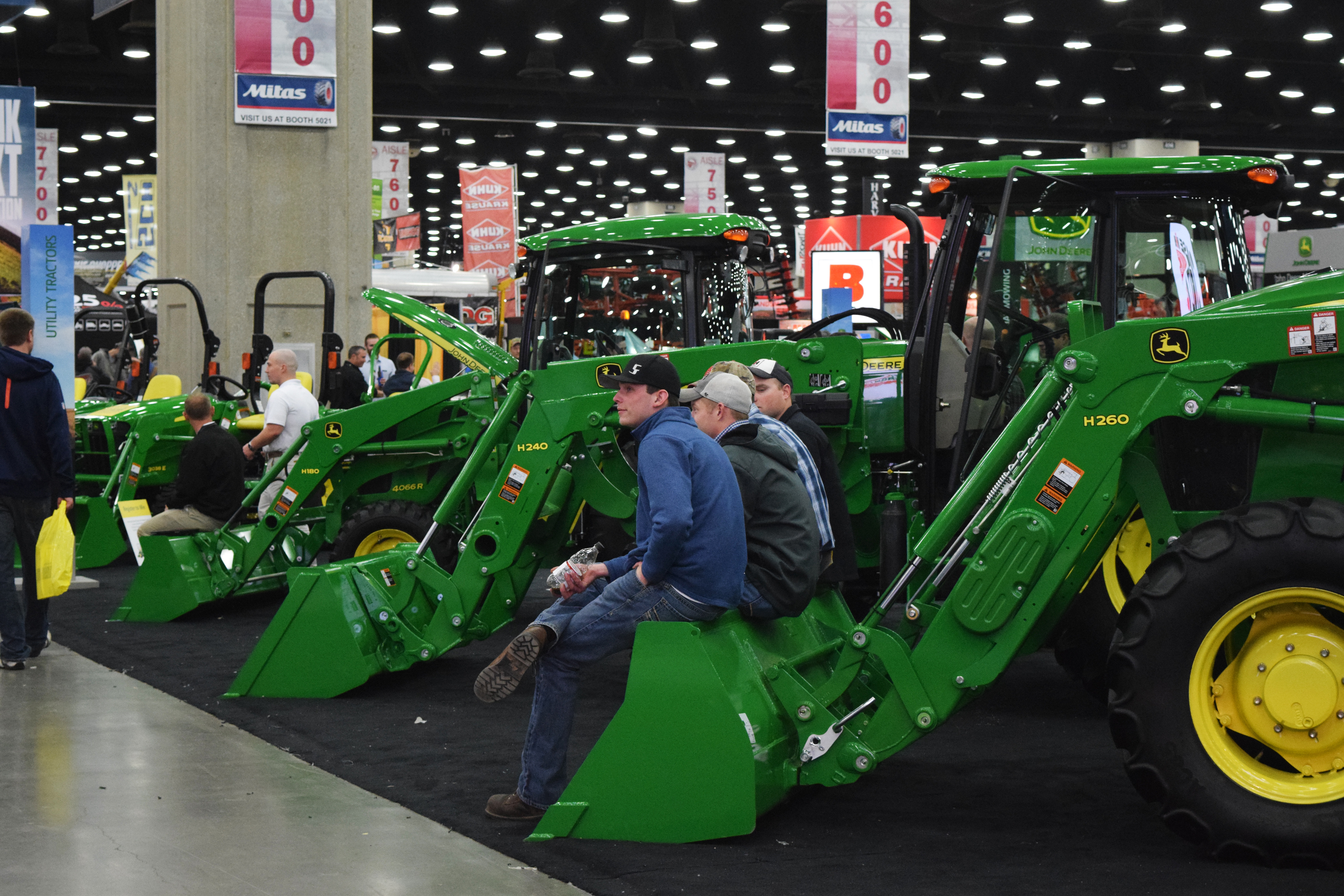 People look at Deere equipment as they attend National Farm Machinery show in Louisville