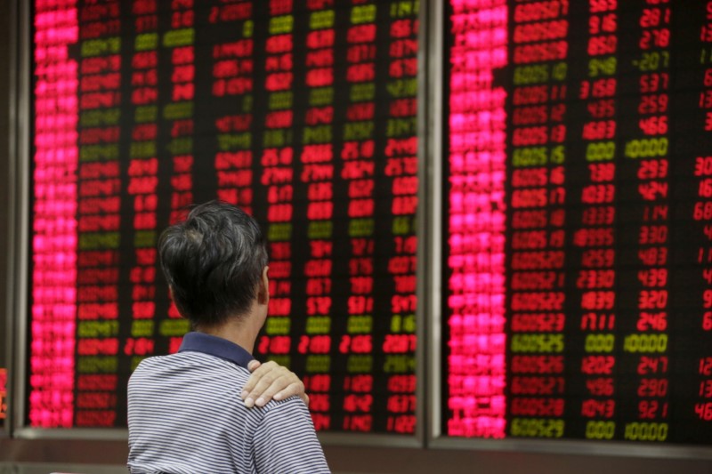 An investor looks at an electronic board showing stock information at a brokerage house in Beijing, August 27, 2015. REUTERS/Jason Lee/File Photo