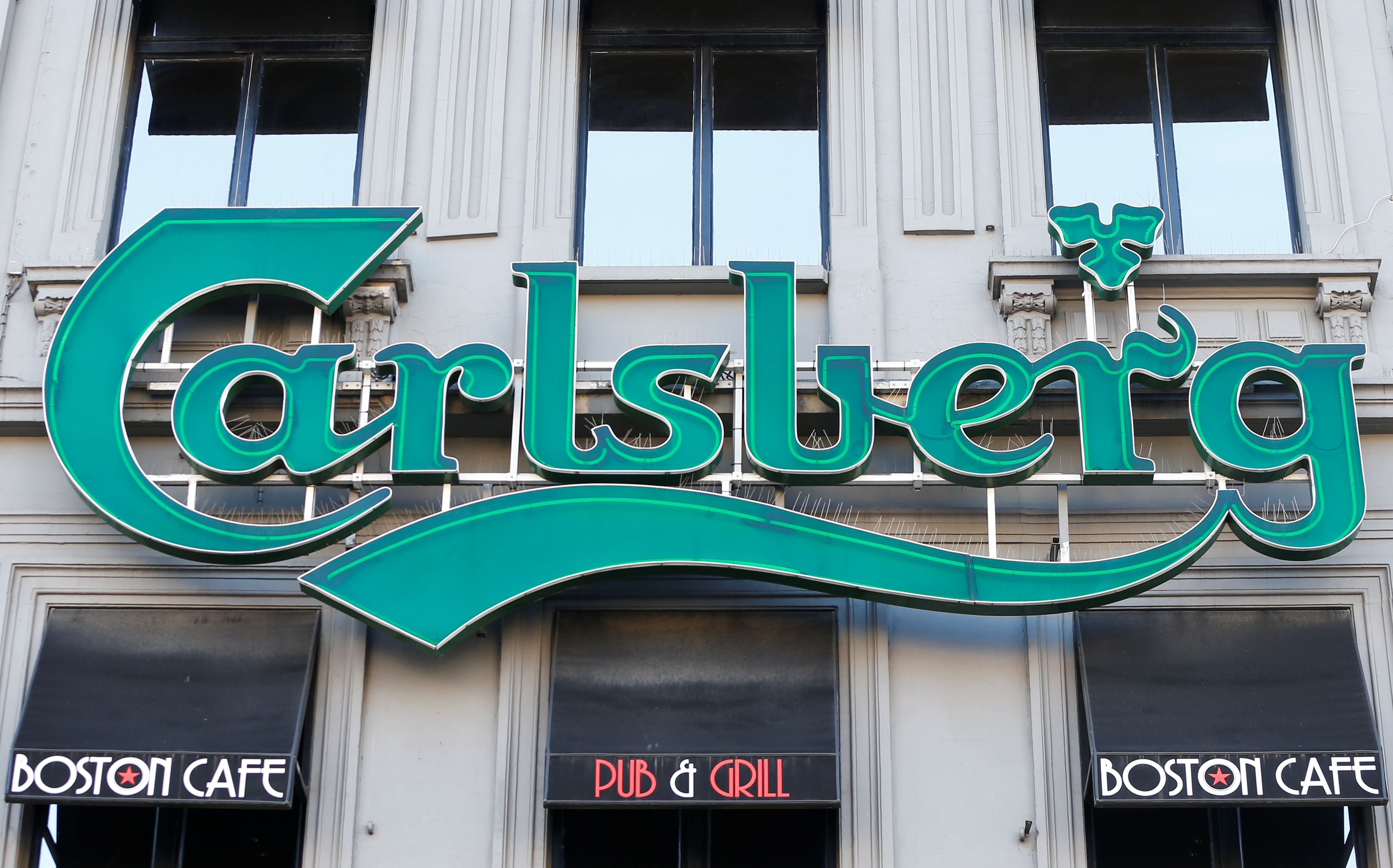 A logo of Carlsberg beer is seen on the entrance of a pub in Brussels