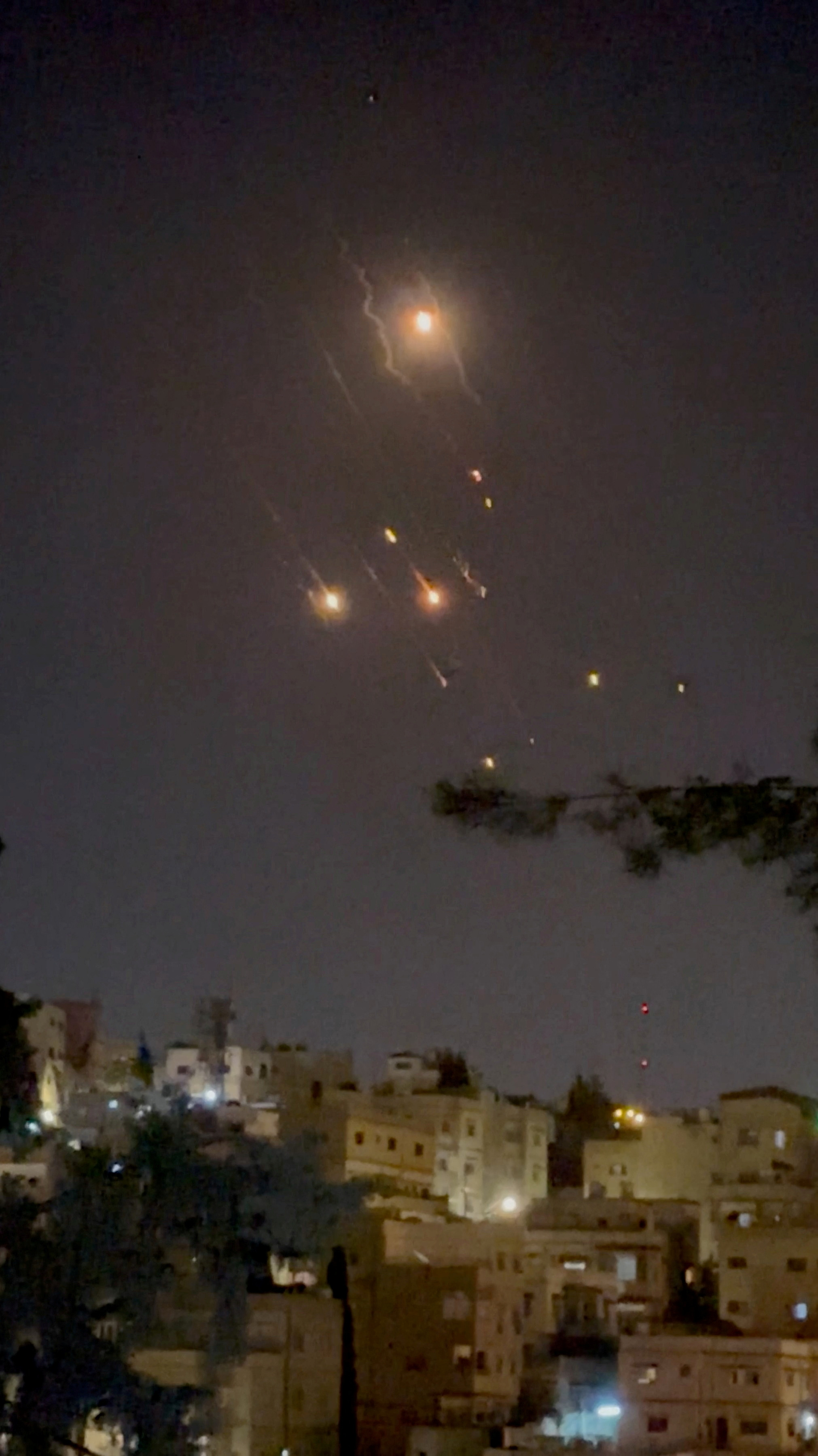 Objects are seen in the sky over Amman after Iran launched drones towards Israel