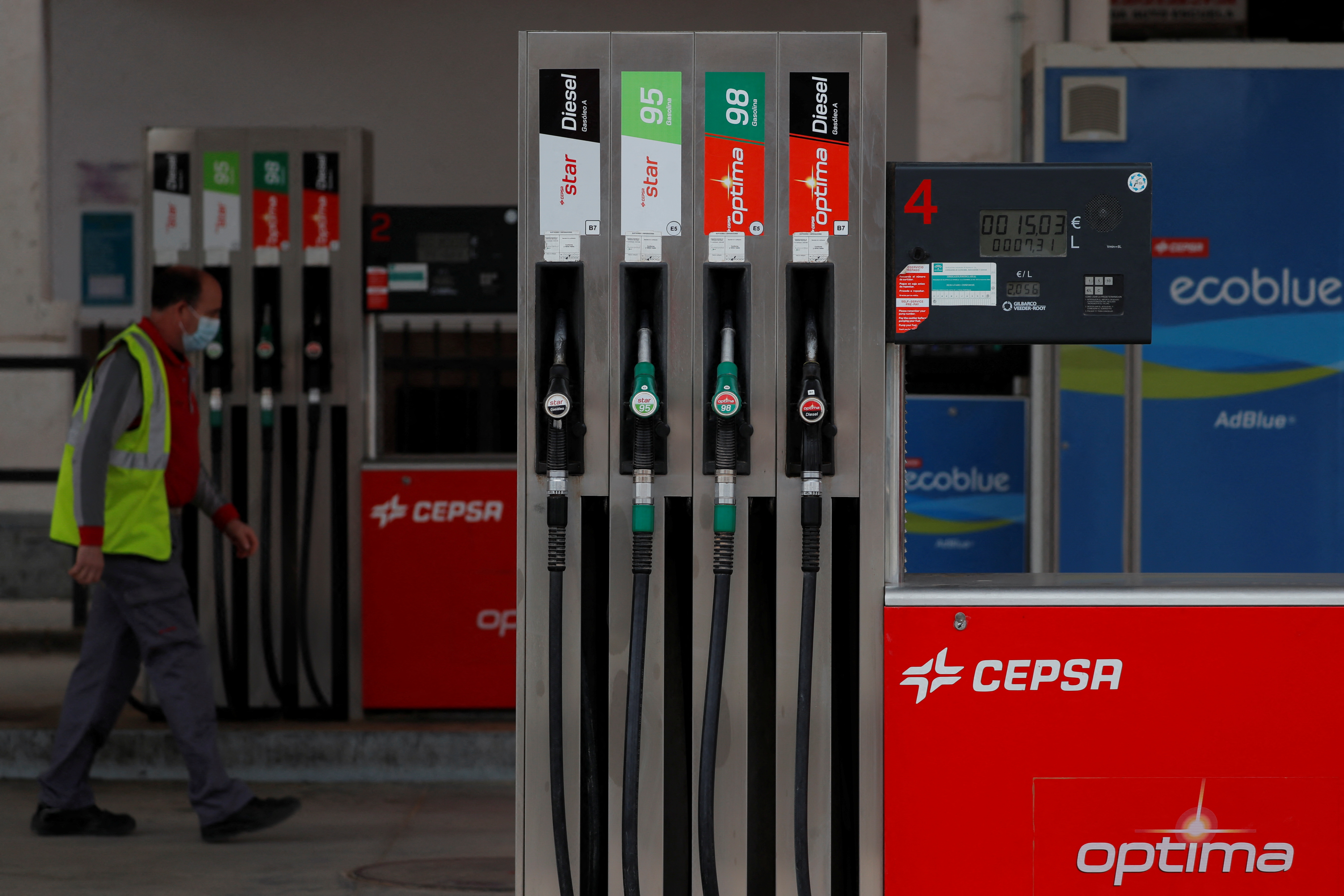 A worker walks past fuel pumps at a Cepsa petrol station in Ronda