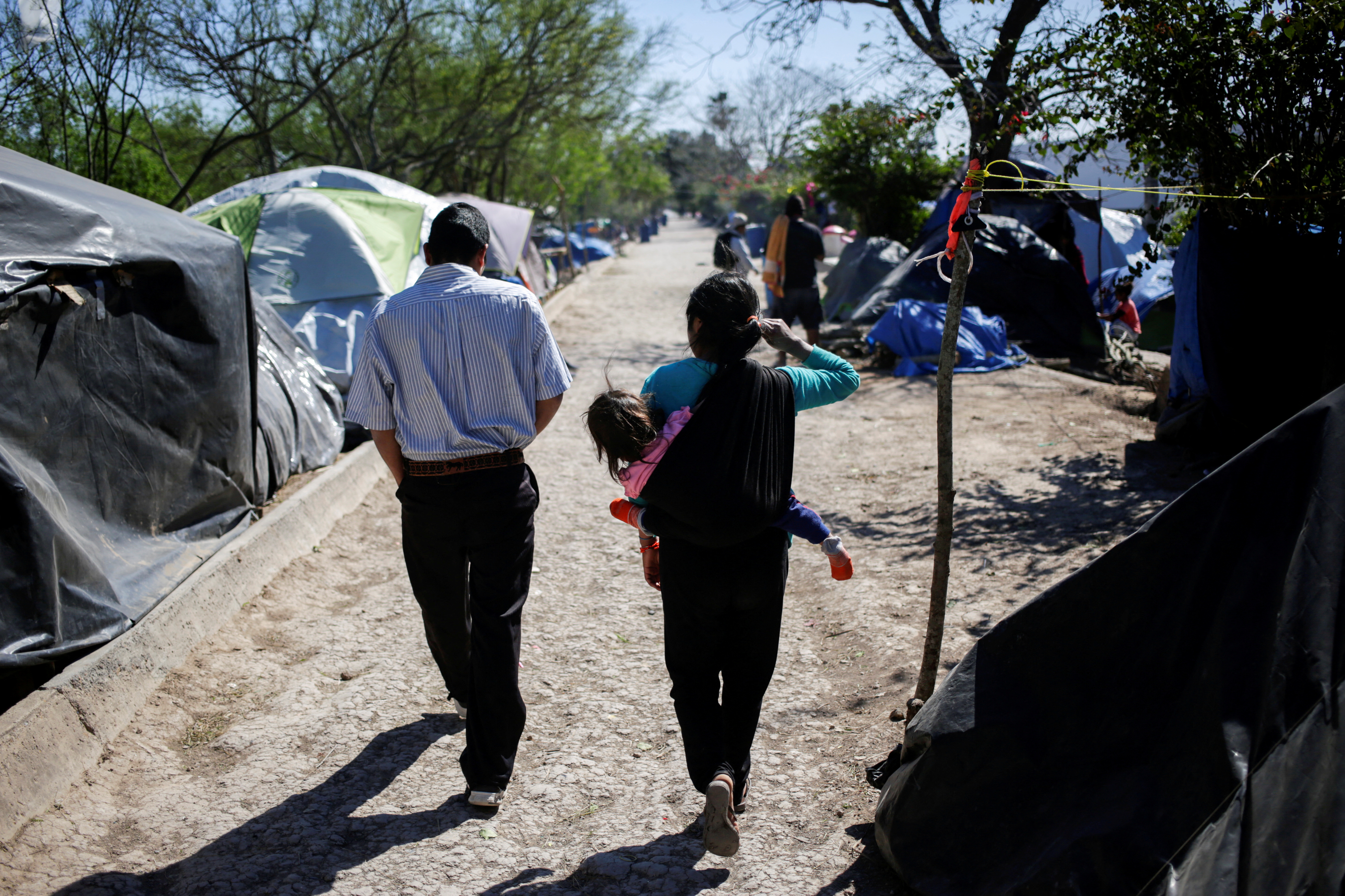 Migrants, asylum seekers sent back to Mexico from the U.S. under the Remain in Mexico program officially named Migrant Protection Protocols (MPP), are seen at provisional campsite near the Rio Bravo in Matamoros