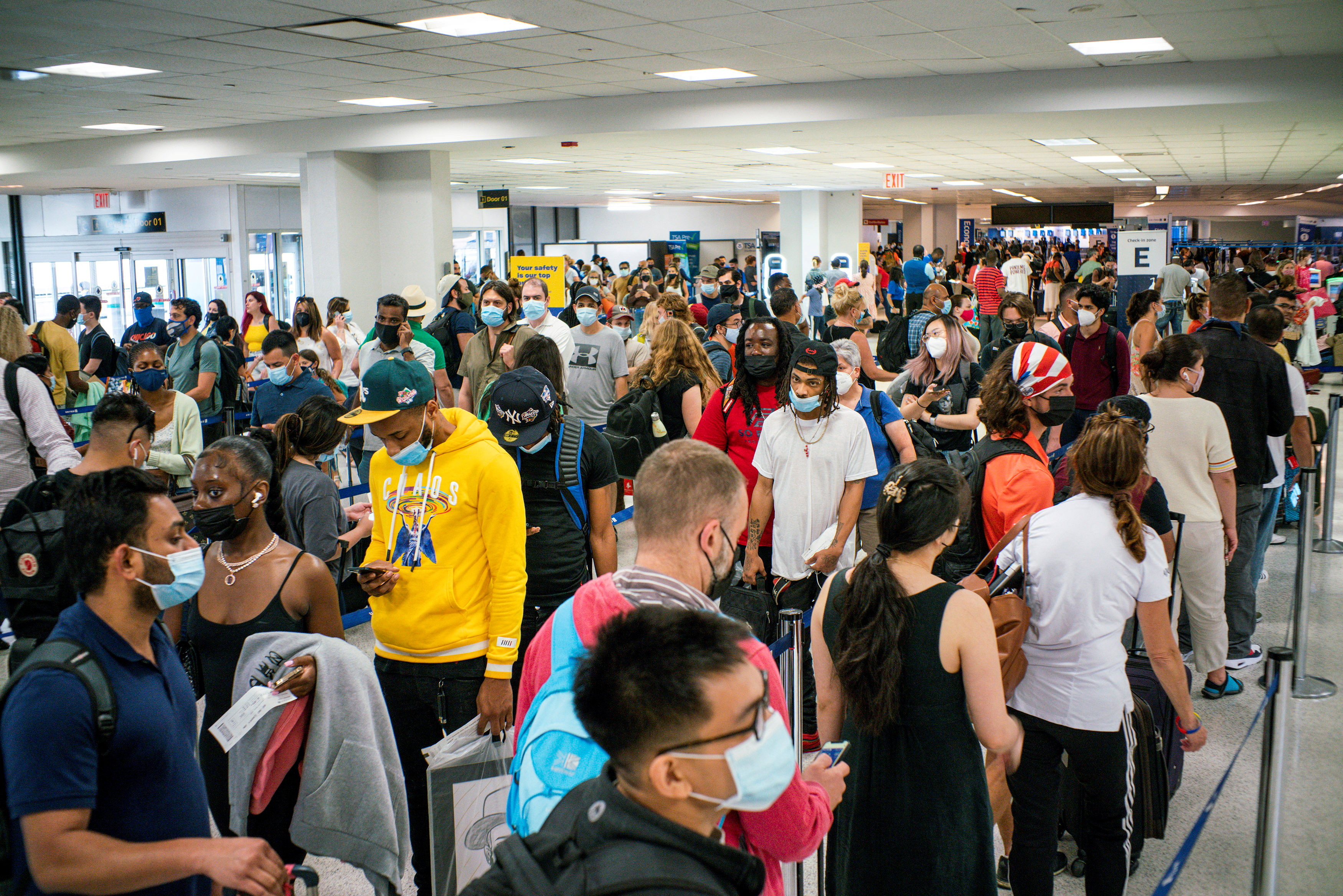Travellers wait in line for immigration processing at the Newark Liberty International Airport, in Newark, New Jersey