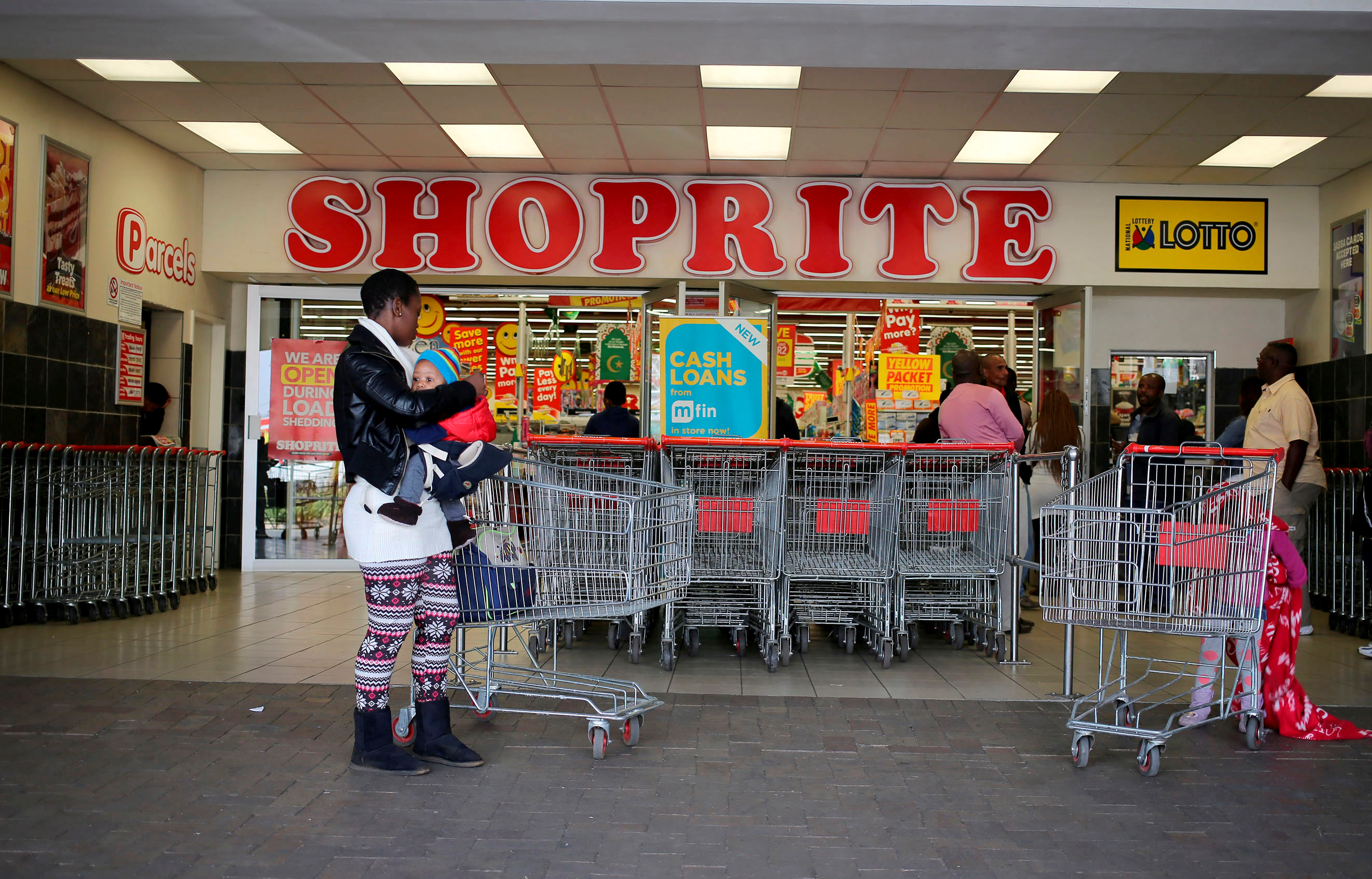 A shopper is seen outside a Shoprite store in Johannesburg