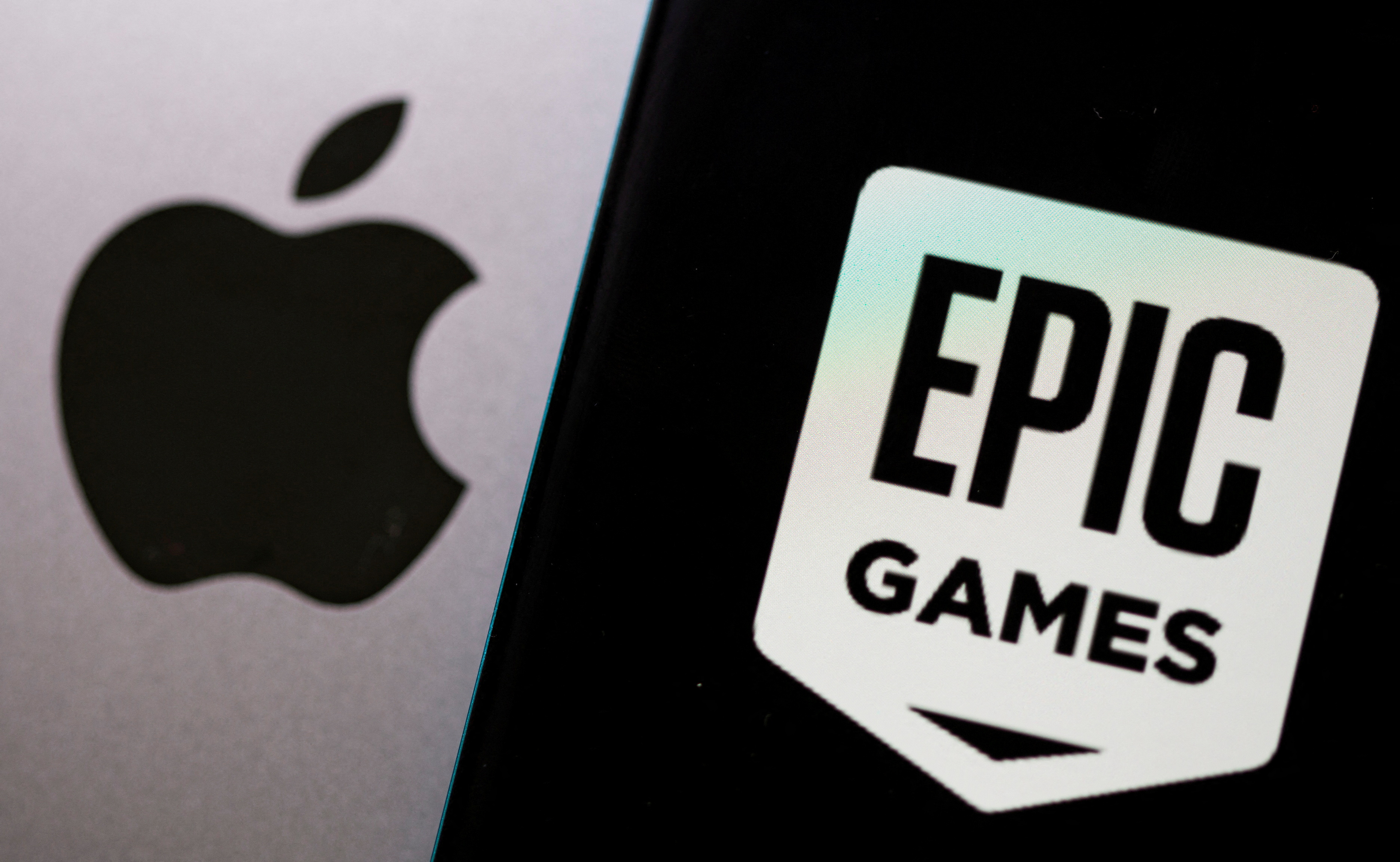 Smartphone with Epic Games logo is seen in front of Apple logo in this illustration taken