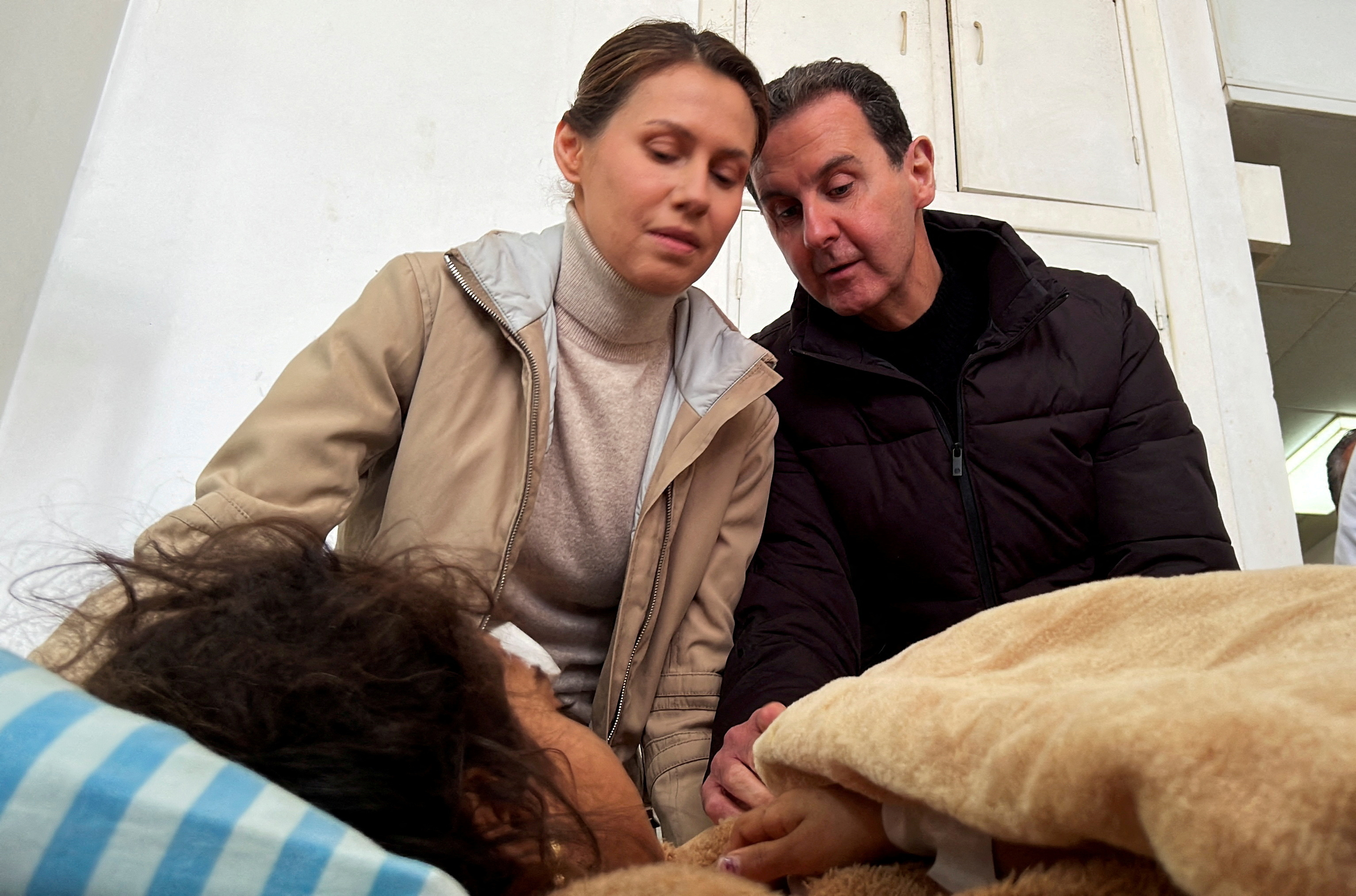 Syrian President Bashar al-Assad and his wife Asma visit an injured girl at Tishreen hospital in Latakia