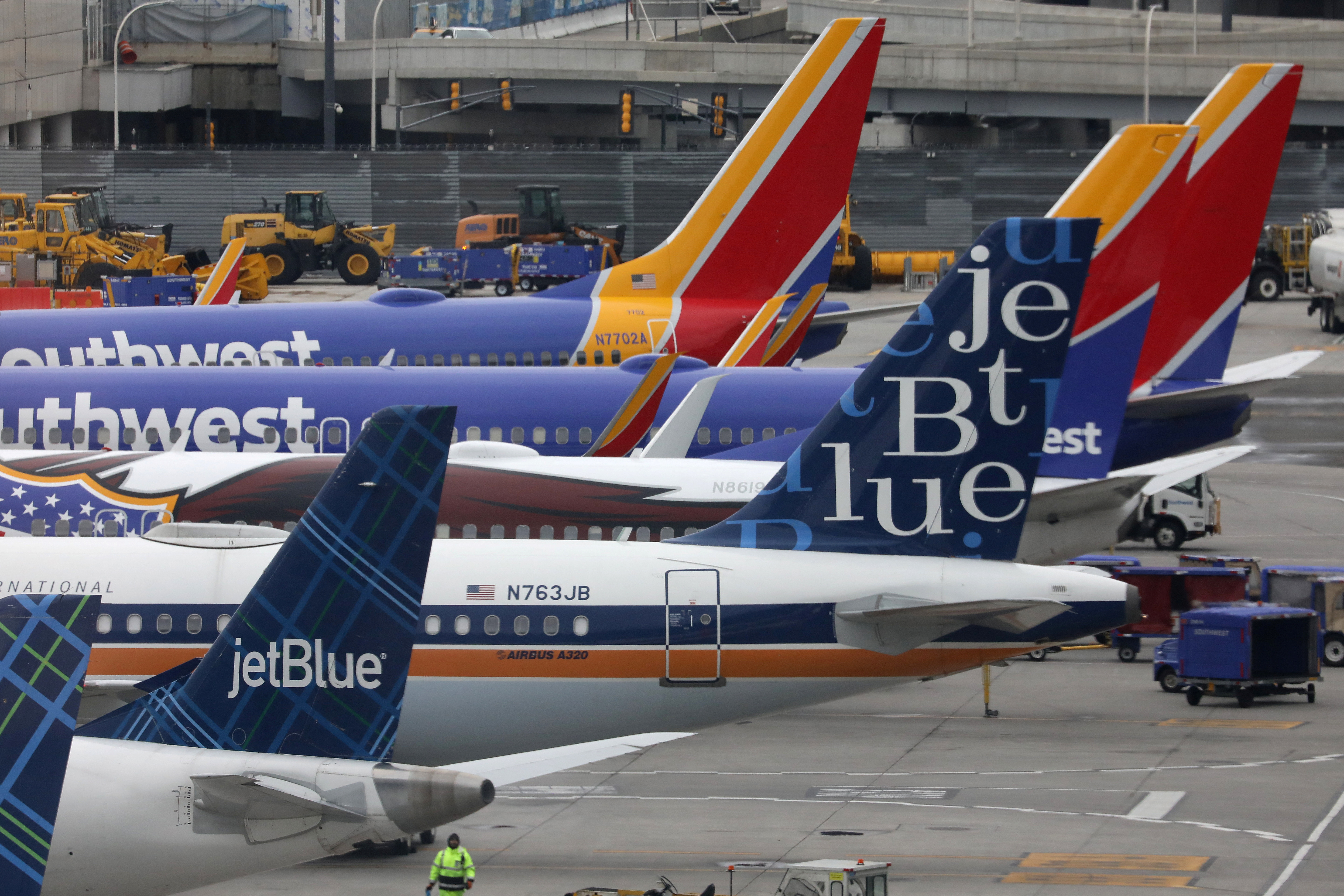 JetBlue and Southwest Airlines planes are parked at LaGuardia Airport in New York City