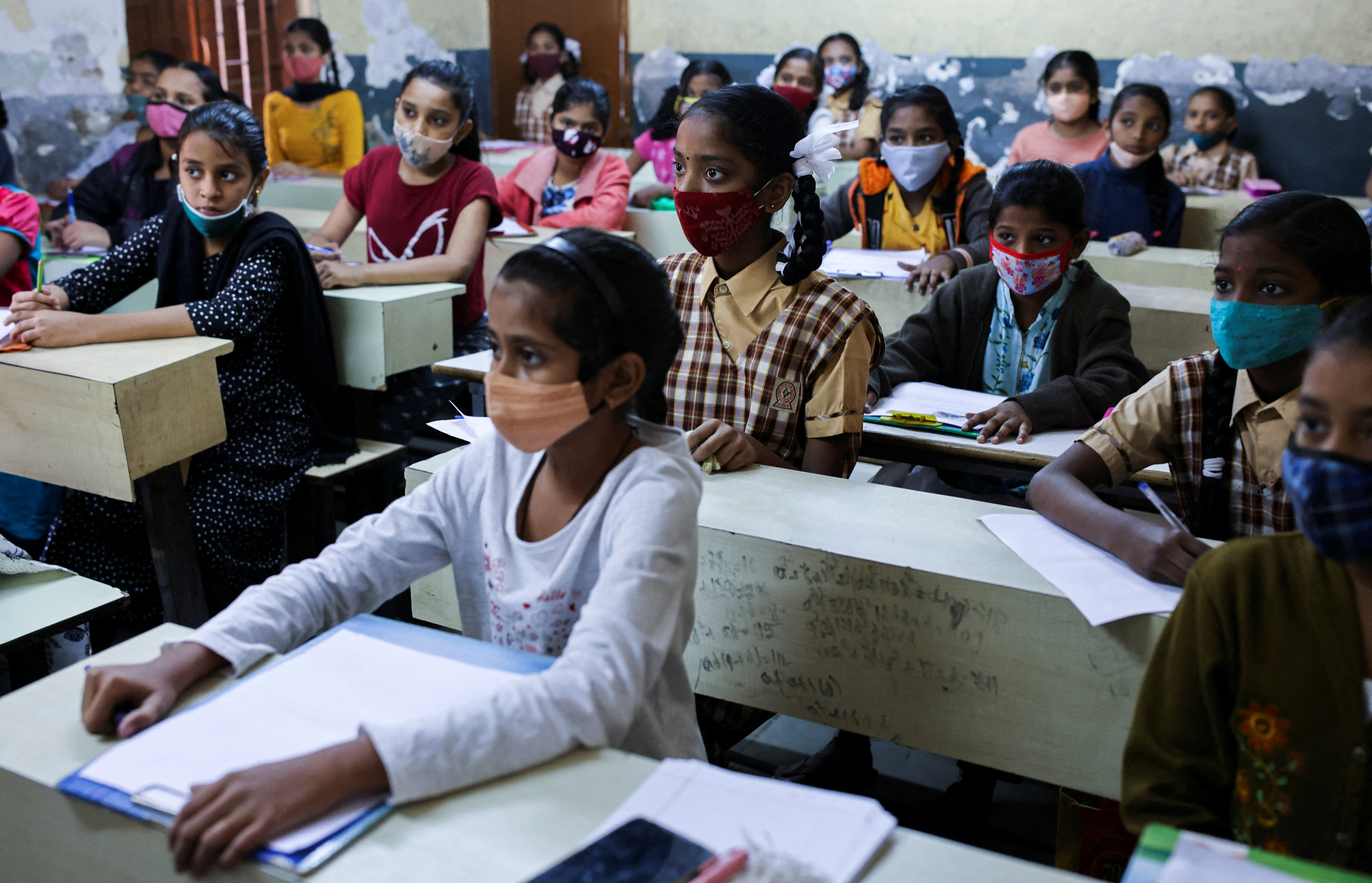 Students attend class in a school after they reopened amidst the spread of the coronavirus disease (COVID-19) pandemic in Mumbai
