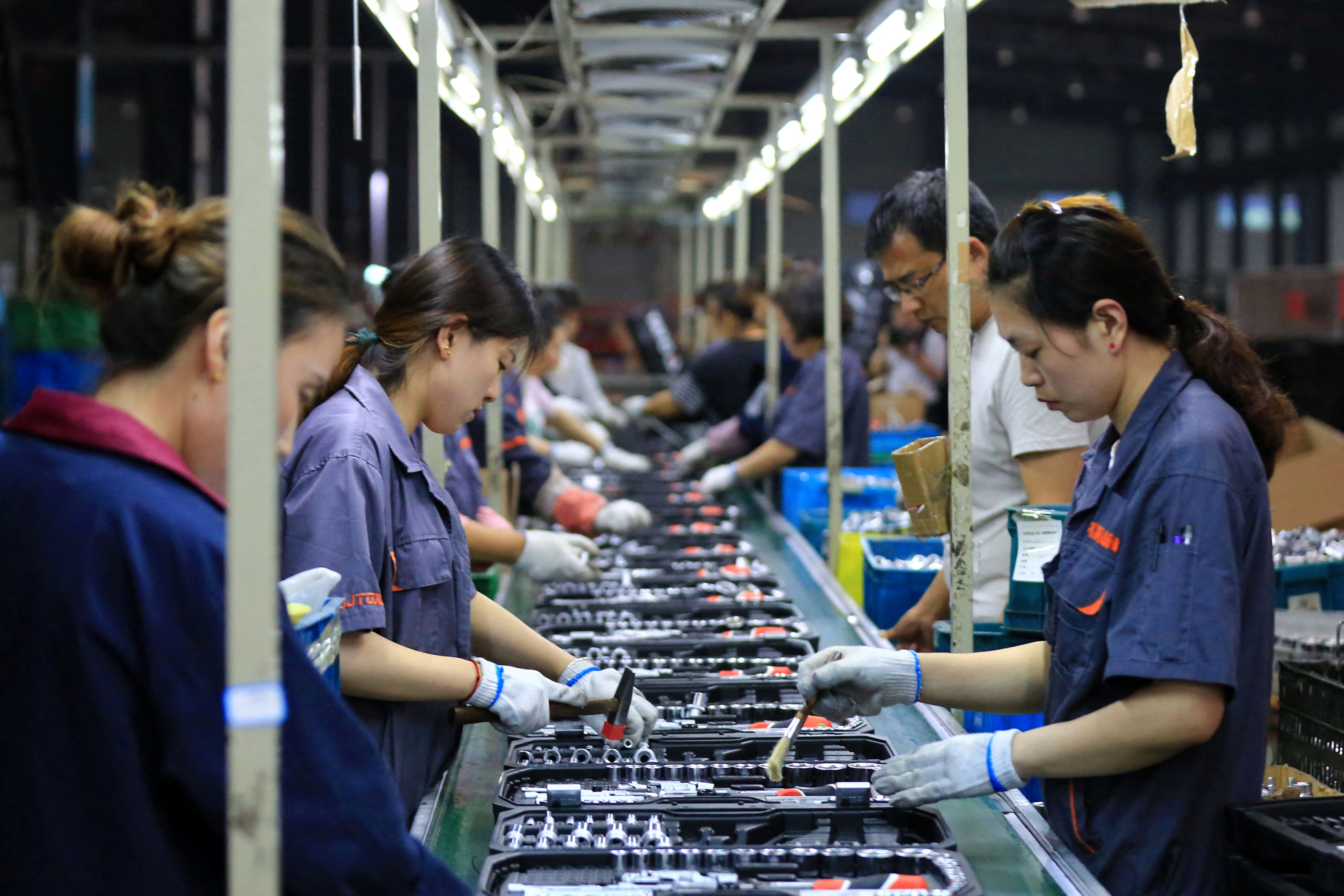Employees work on a production line manufacturing tools at a factory in Huaian