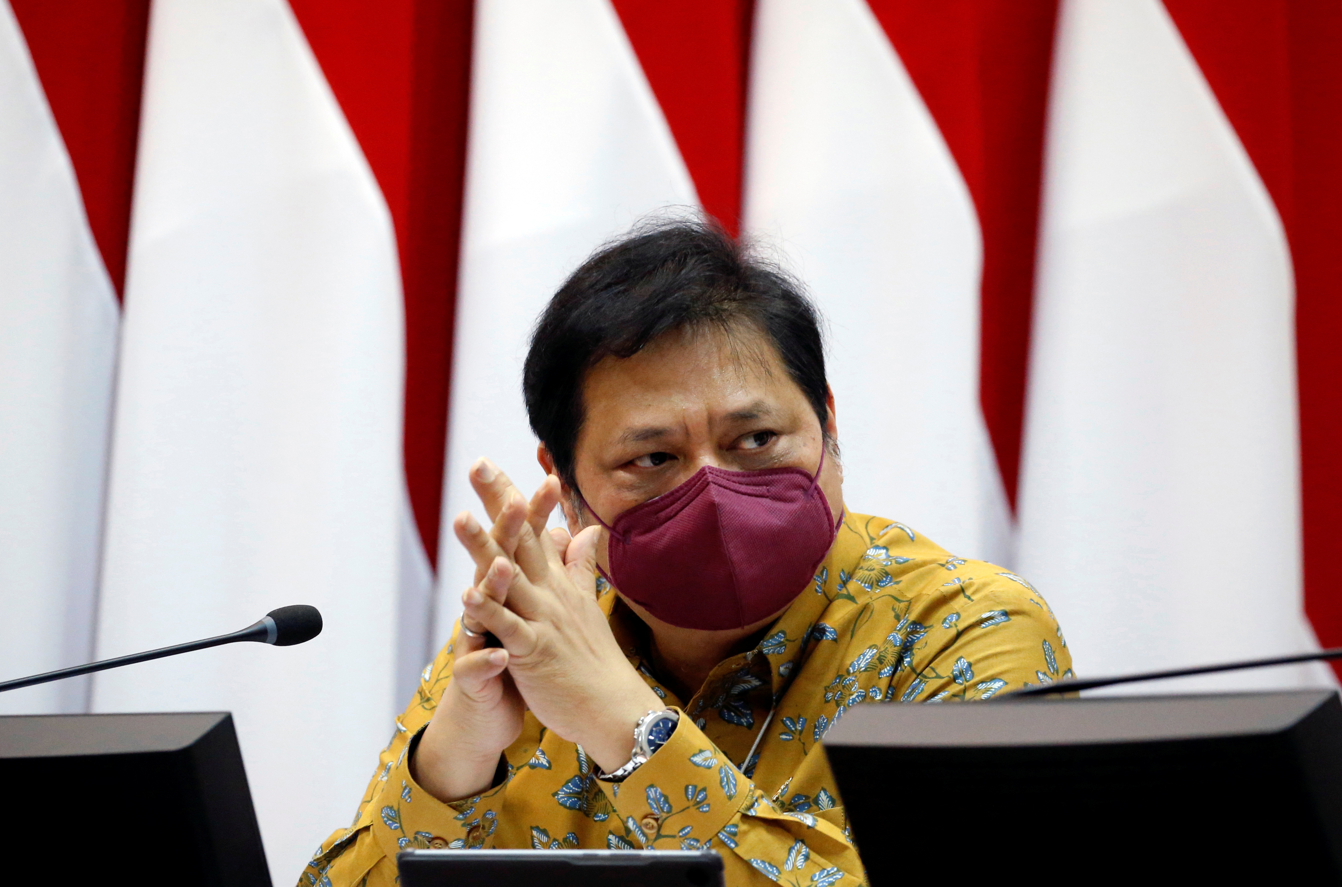 Airlangga Hartarto, Indonesia's Coordinating Minister for Economic Affairs, wearing a protective mask reacts during an interview with Reuters at the Presidential Palace in Jakarta