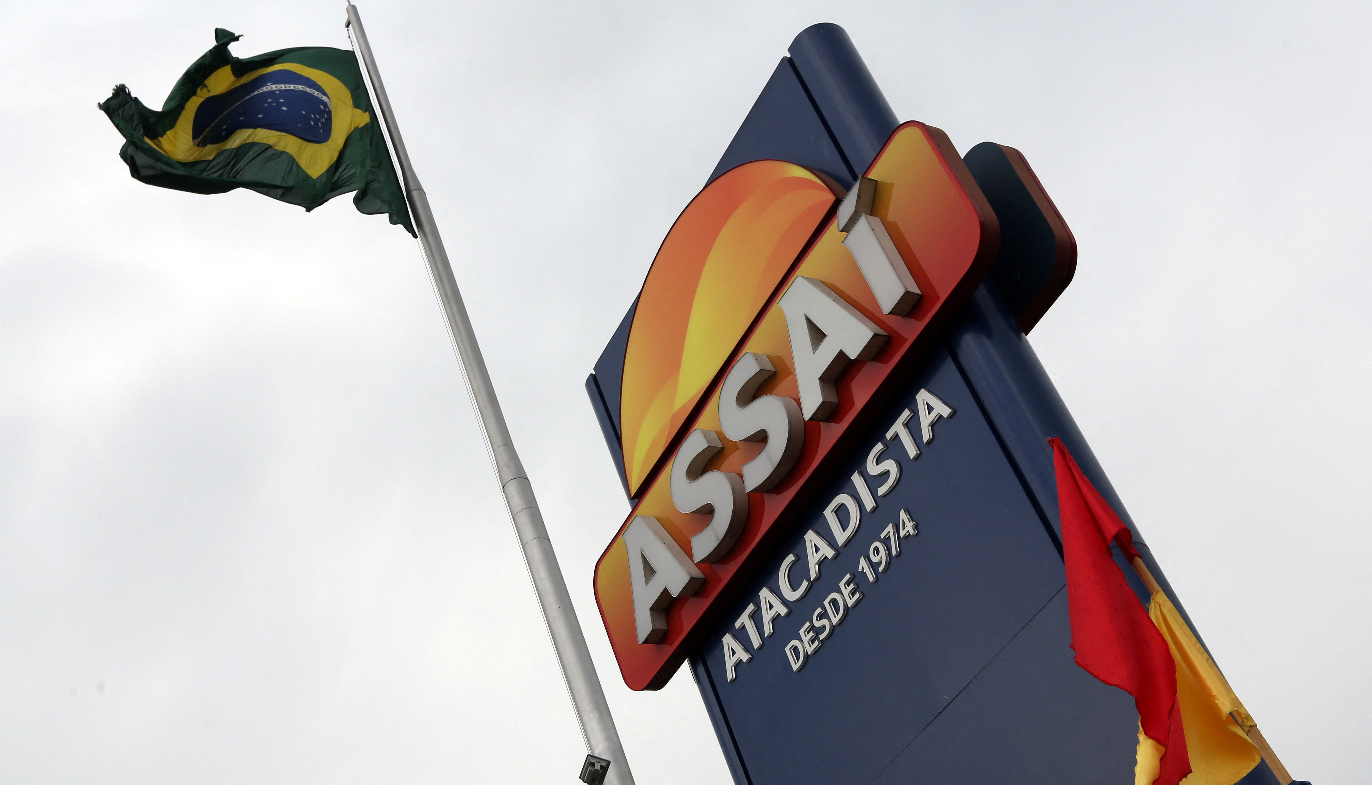 The logo of Assai is pictured next to the Brazilian national flag in Sao Paulo