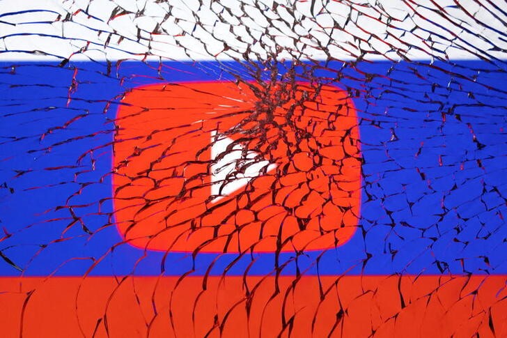 Illustration shows Youtube logo and Russian flag through broken glass