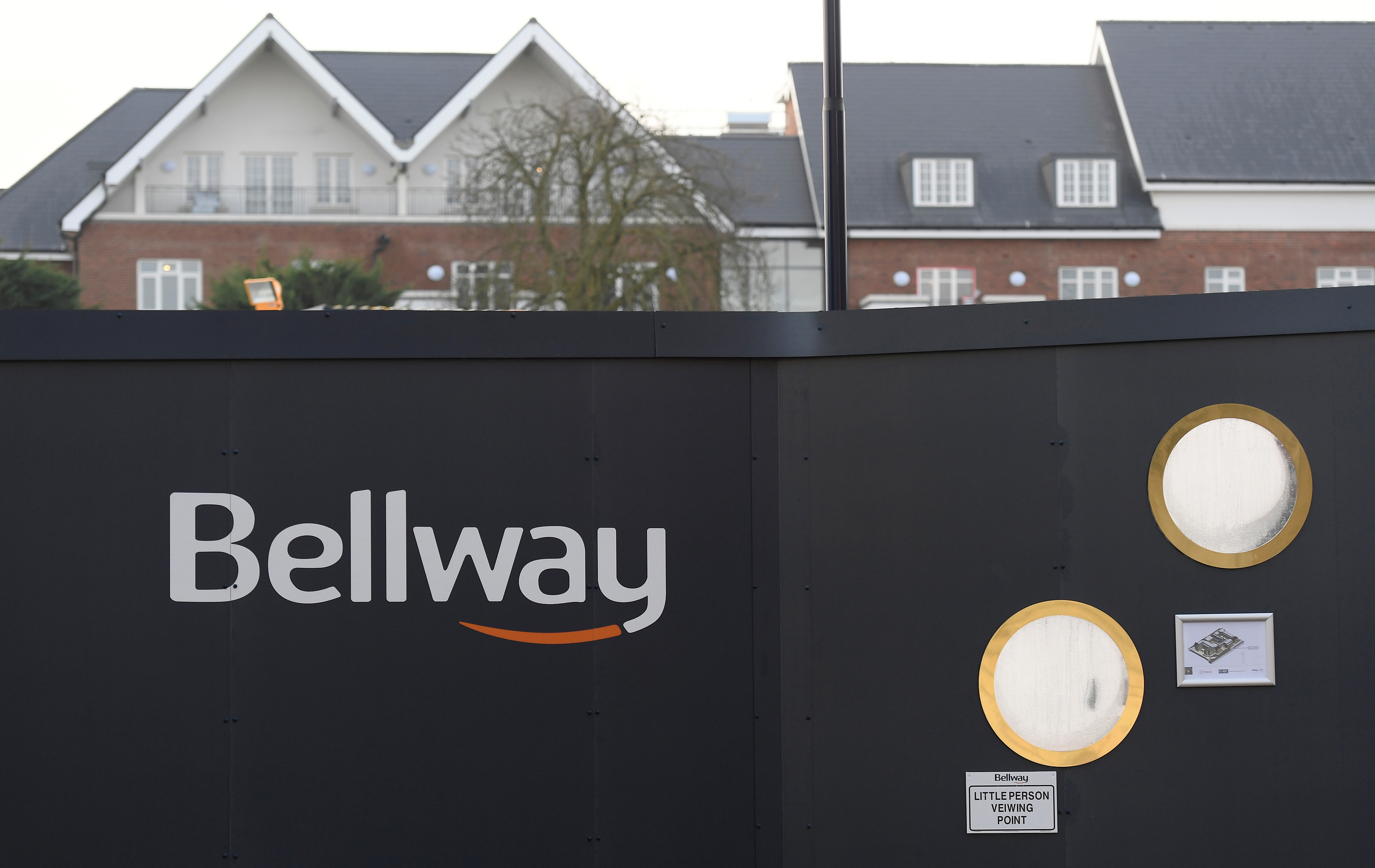 A Bellway sign is seen at a housing construction site in London