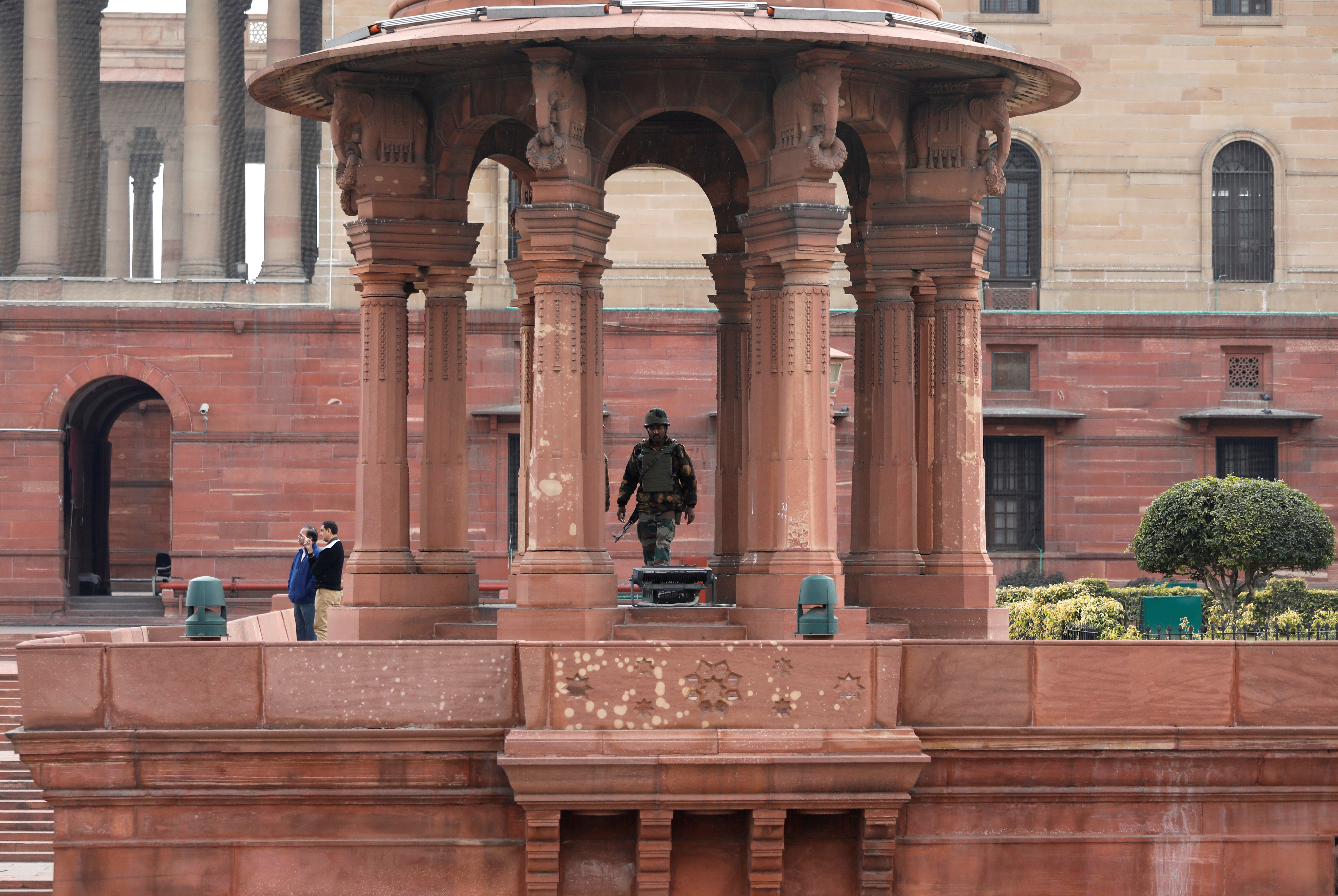 An armed soldier stands guard outside India's Defence Ministry building in New Delhi