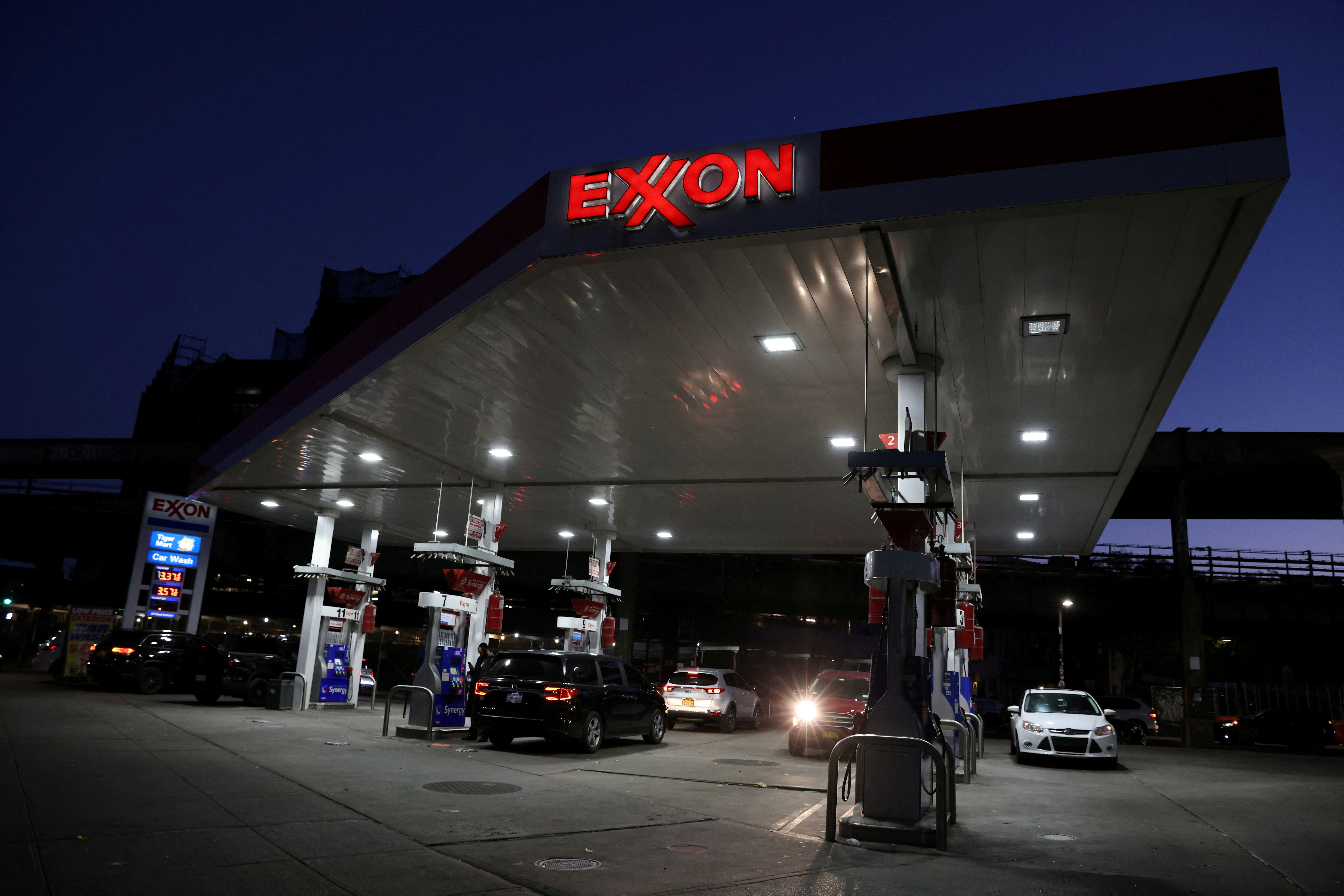 Cars are seen at an Exxon gas station in Brooklyn, New York City