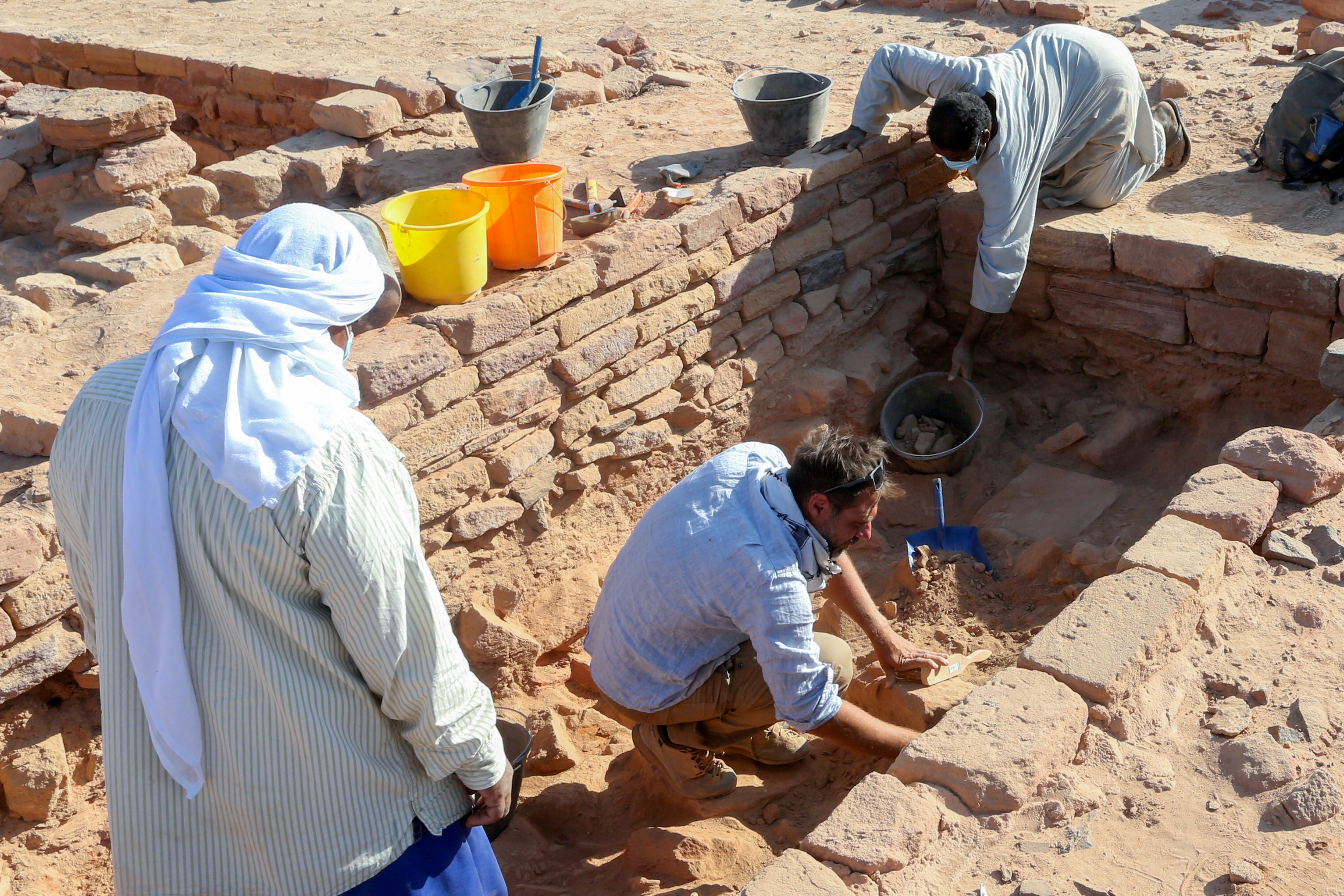 A French archaeologist and his co-workers carefully clean the pottery to examine the findings known to be from Dadan and Lihyan civilisation dated back to the second half of the first millennium BC, in Al-Ula, Saudi Arabia October 30, 2021. REUTERS/Ahmed Yosri