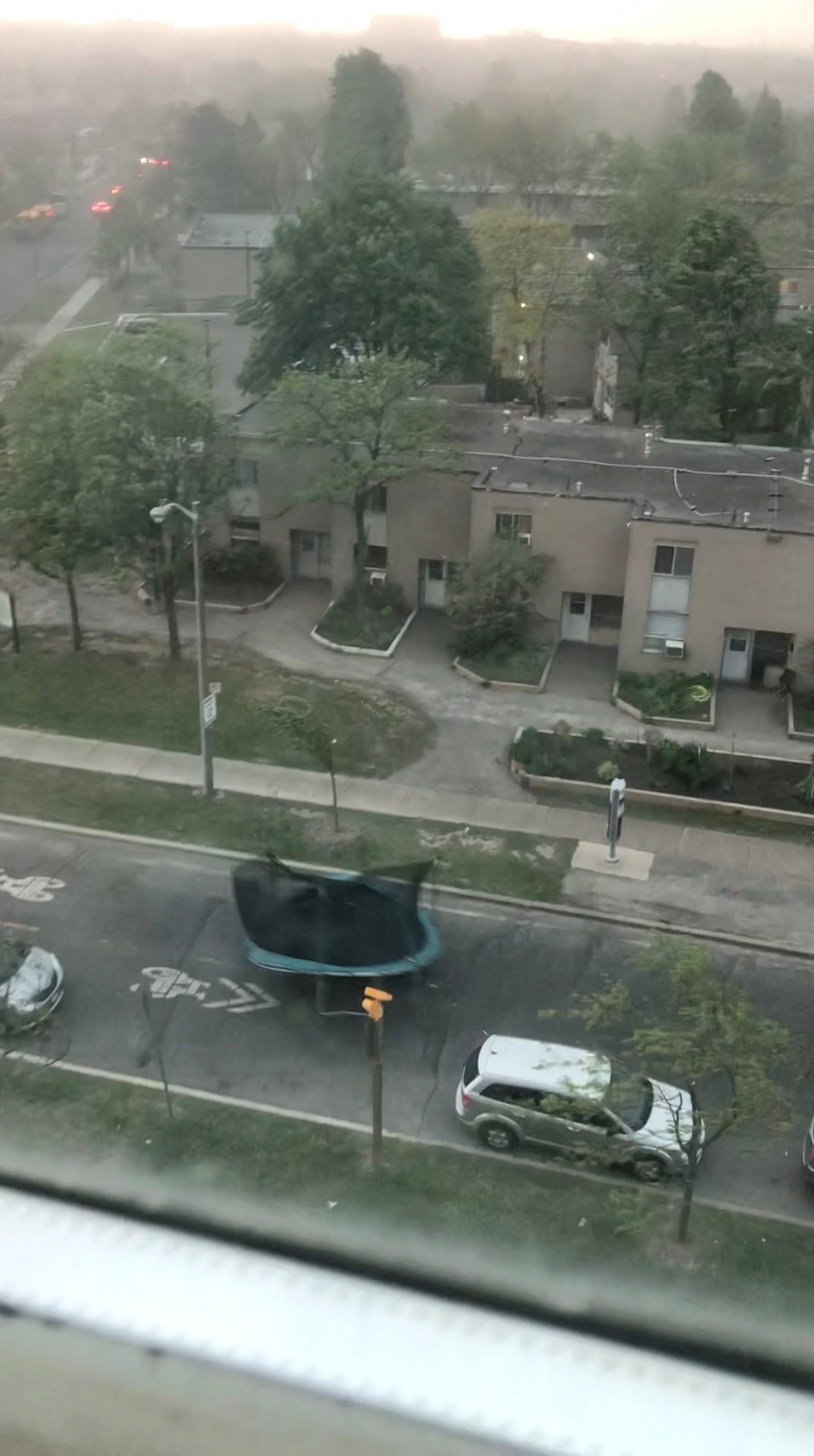 A trampoline is blown down a street during a storm in Toronto