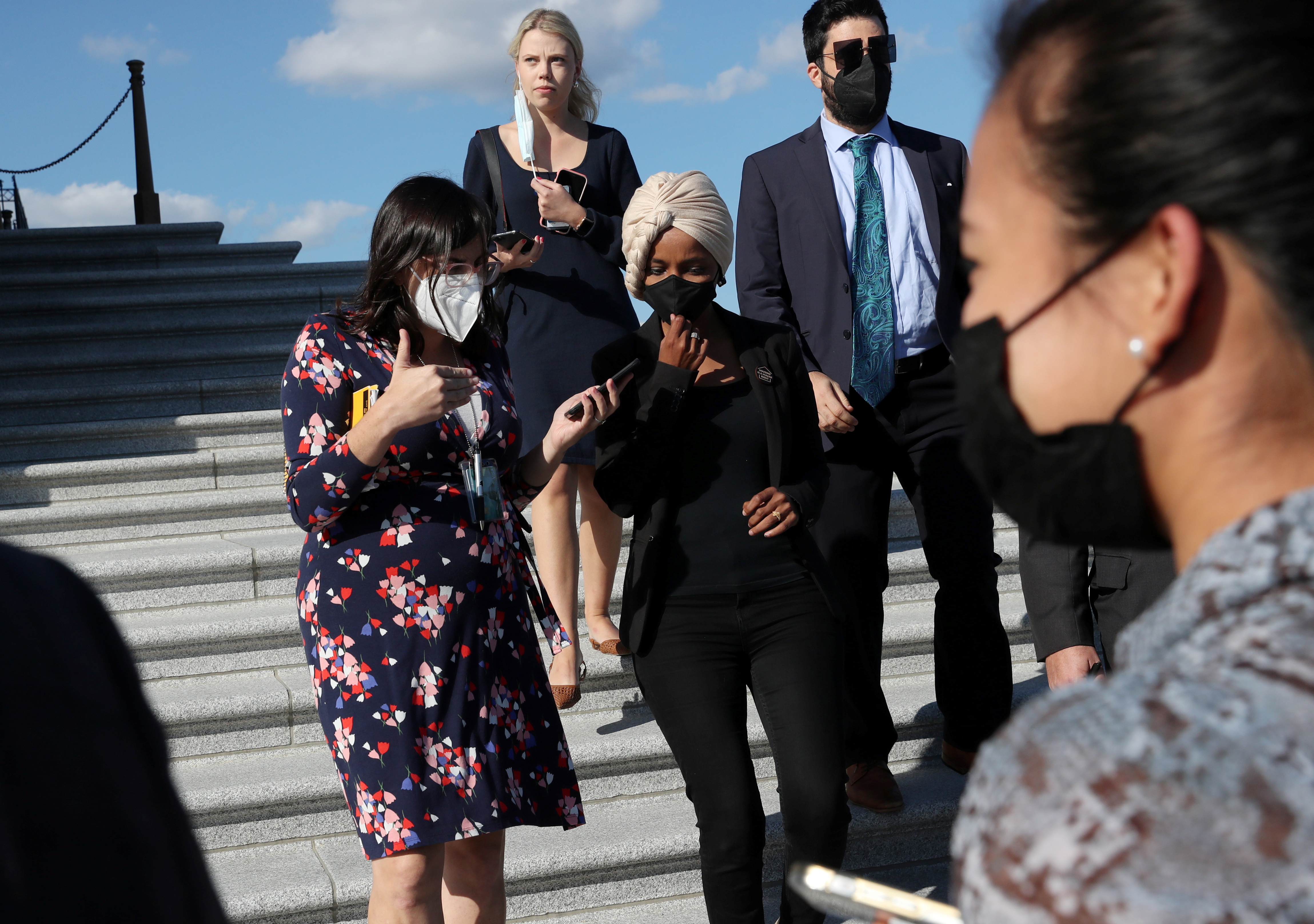 Reporters talk with U.S. Rep. Ilhan Omar (D-MN) as she leaves the U.S. Capitol building after a vote on Capitol Hill in Washington, U.S., September 30, 2021. REUTERS/Leah Millis