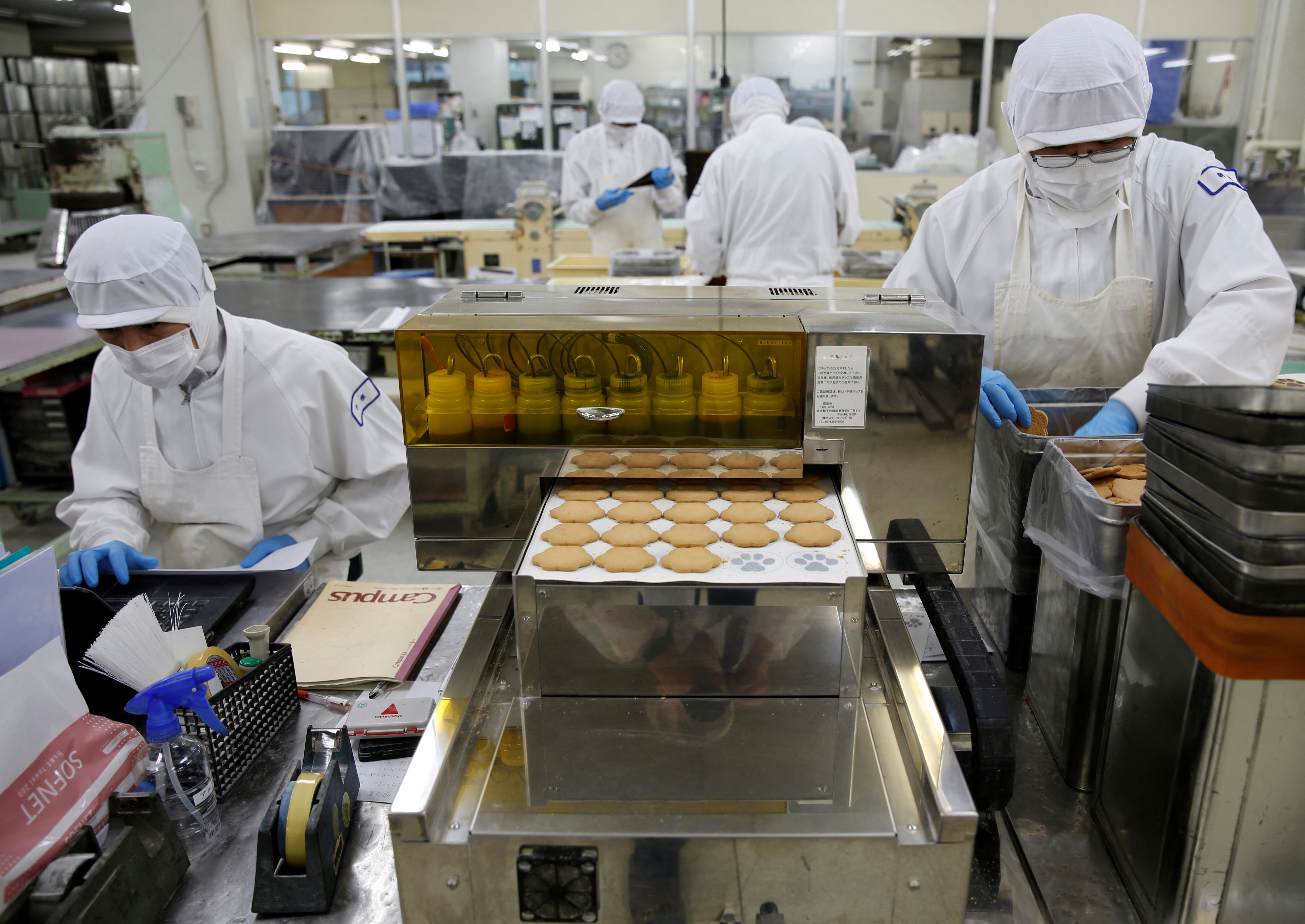 Employees of Izumiya Tokyoten work on a production line at its factory in Kawasaki