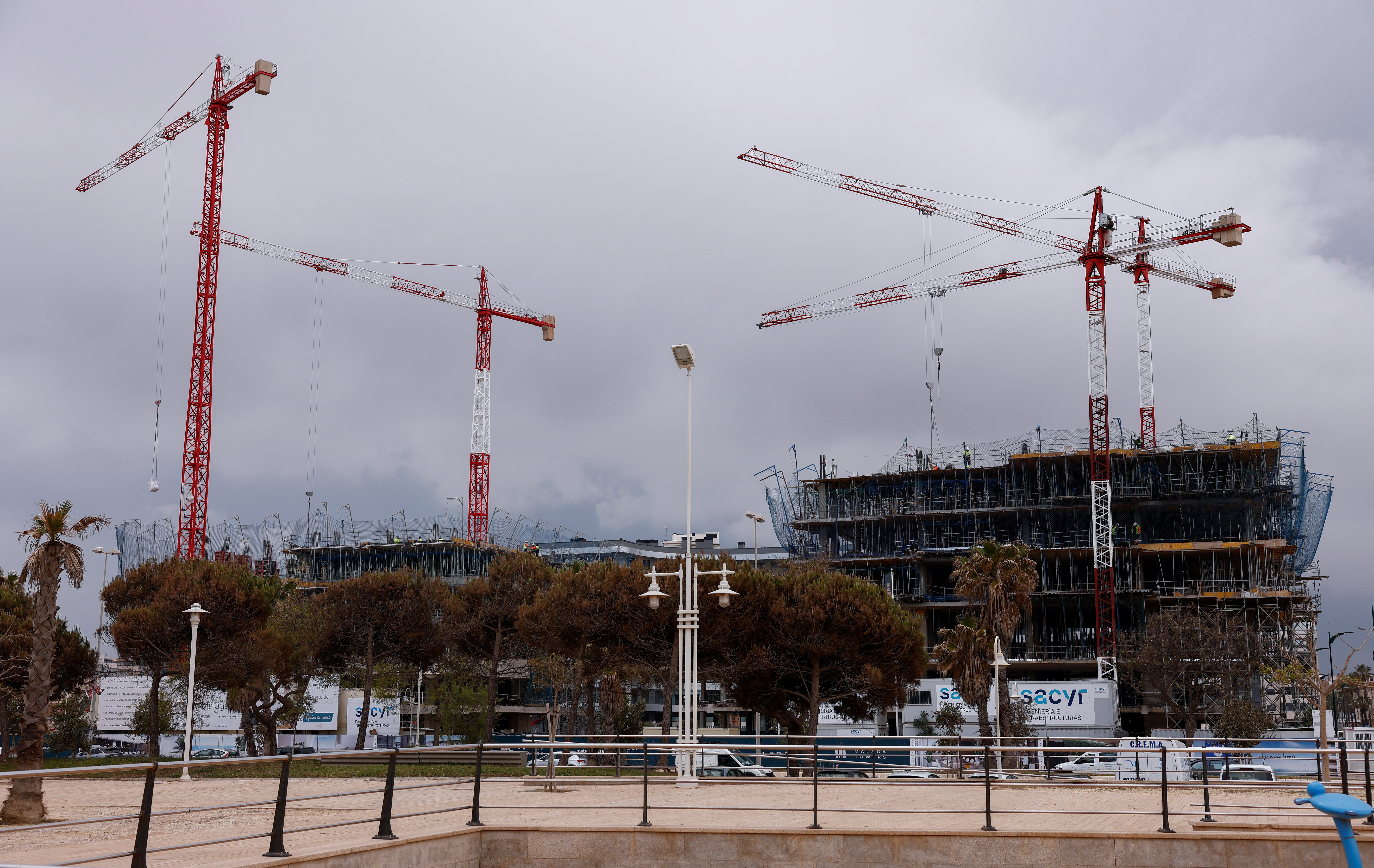 Cranes are seen at the site of an under-construction building in Malaga