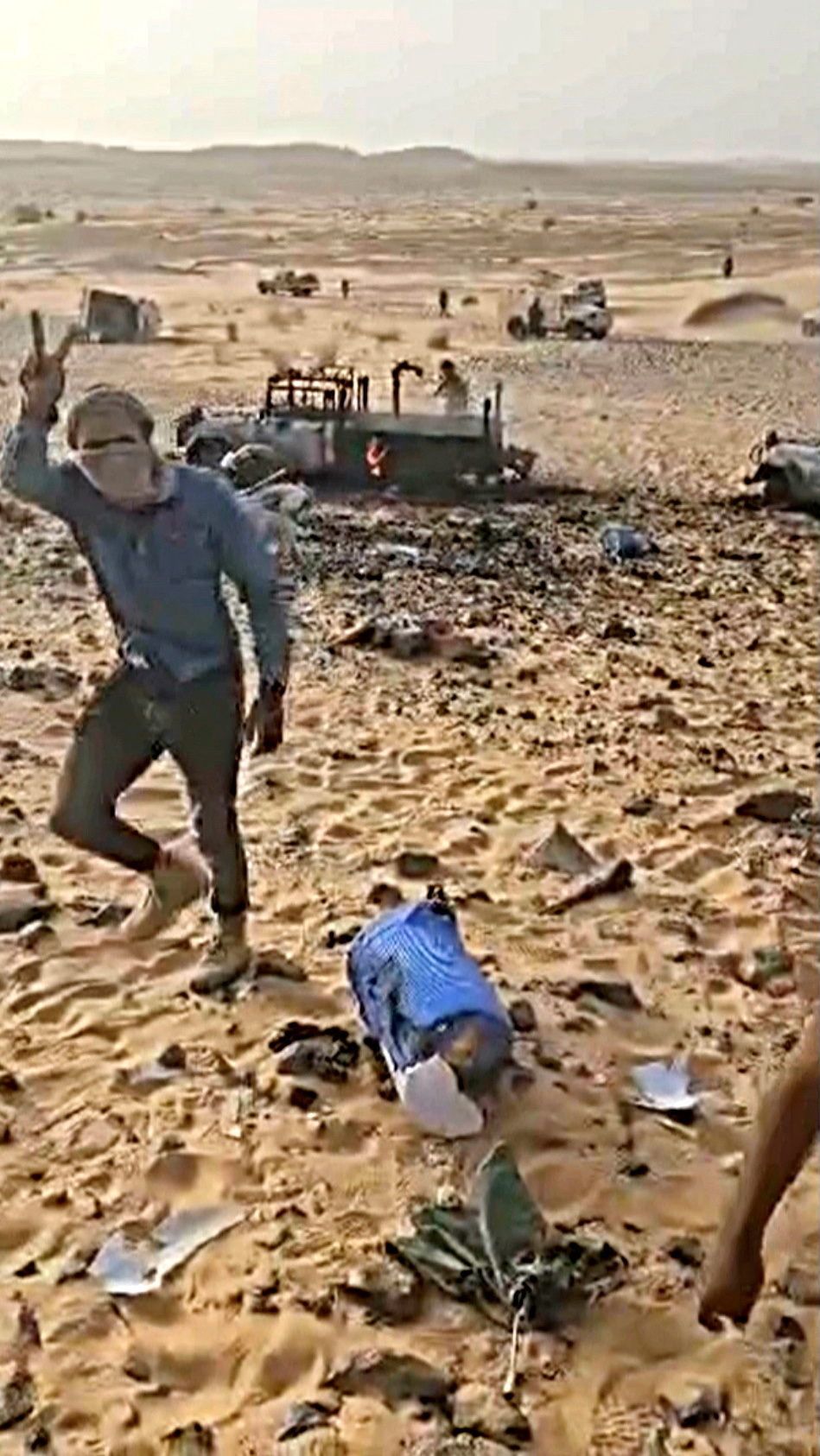 A CMA (Tuareg rebel alliance) fighter gestures among debris and damaged vehicles after clashes between Tuareg rebels and Russian Wagner mercenaries in northeastern Mali, near Tinzaouaten, Mali, July 2024. via Coordination of Azawad Movements dzzdyzeqzydzzyzdzzyuqzzyzdkzyturkyzzzzinv eiqrhiqzdihrprw