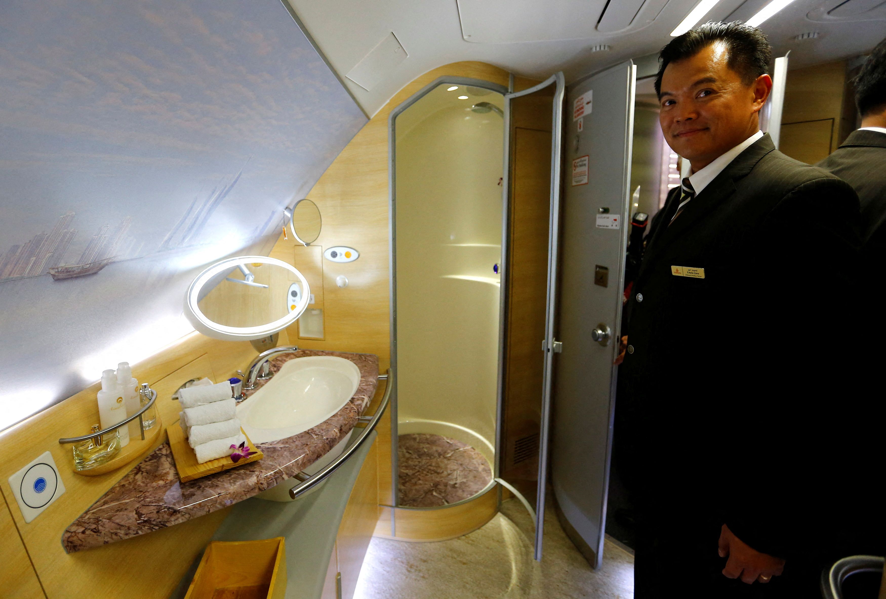 A flight attendant presents the spa area with a shower for first class passengers of United Arab Emirates air carrier Emirates after the first landing of an Emirates Airbus A380 in Frankfurt's airport